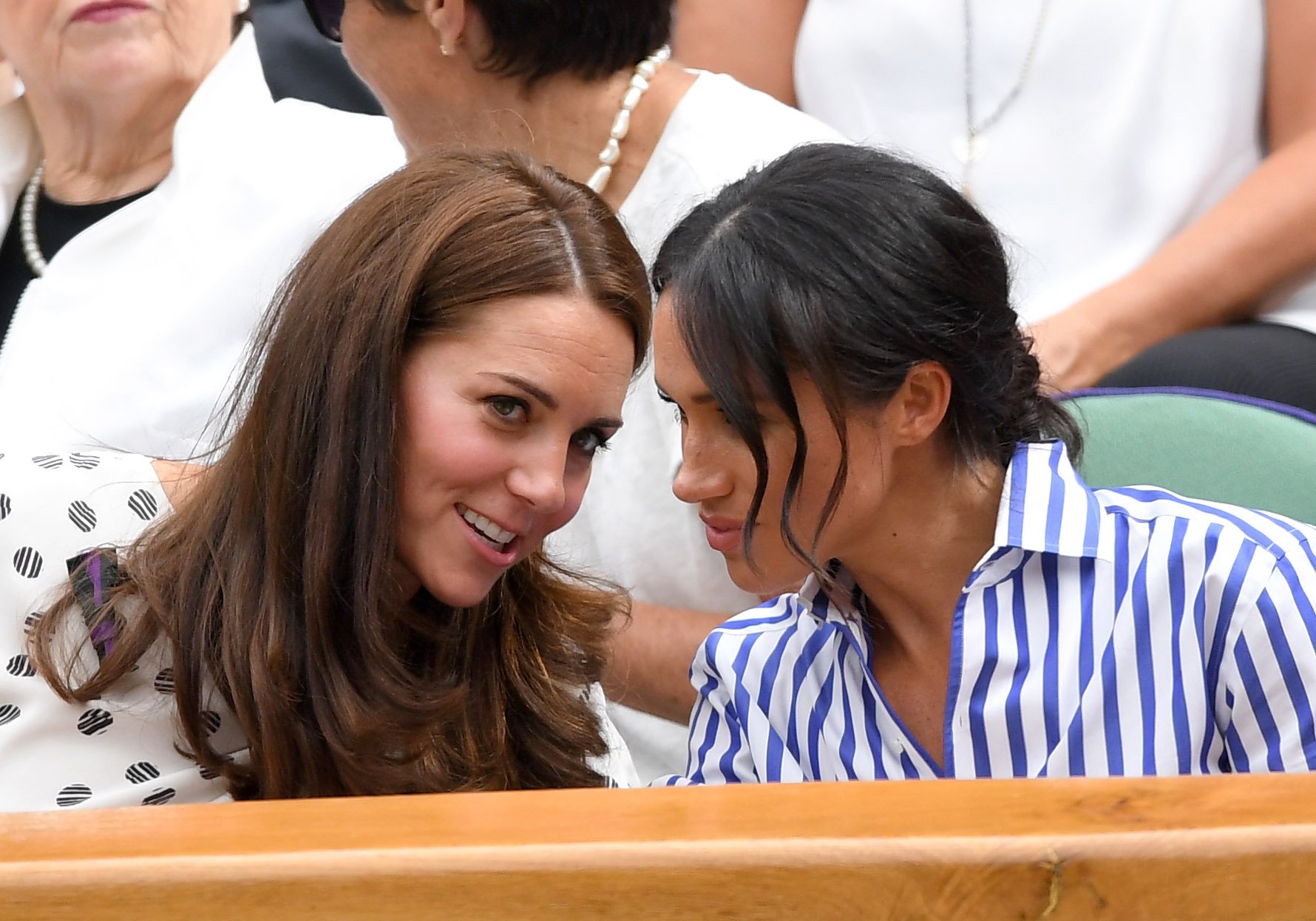 Kate Middleton and Meghan Markle during day twelve of the Wimbledon Tennis Championships at the All England Lawn Tennis and Croquet Club on July 14, 2018 in London, England. | Source: Getty Images