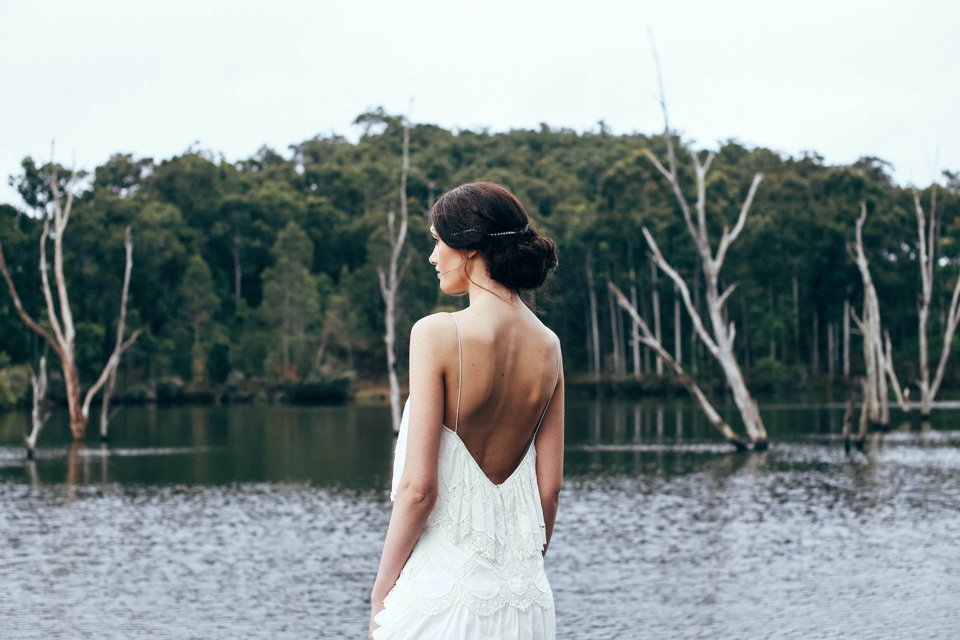 A bride standing near a lake | Source: Pexels