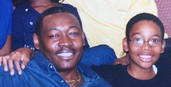 Laurence Thomaz smiles alongside a young Wiz Khalifa in a family photo shared on February 14, 2026. | Source: X/Richmond TWKL™