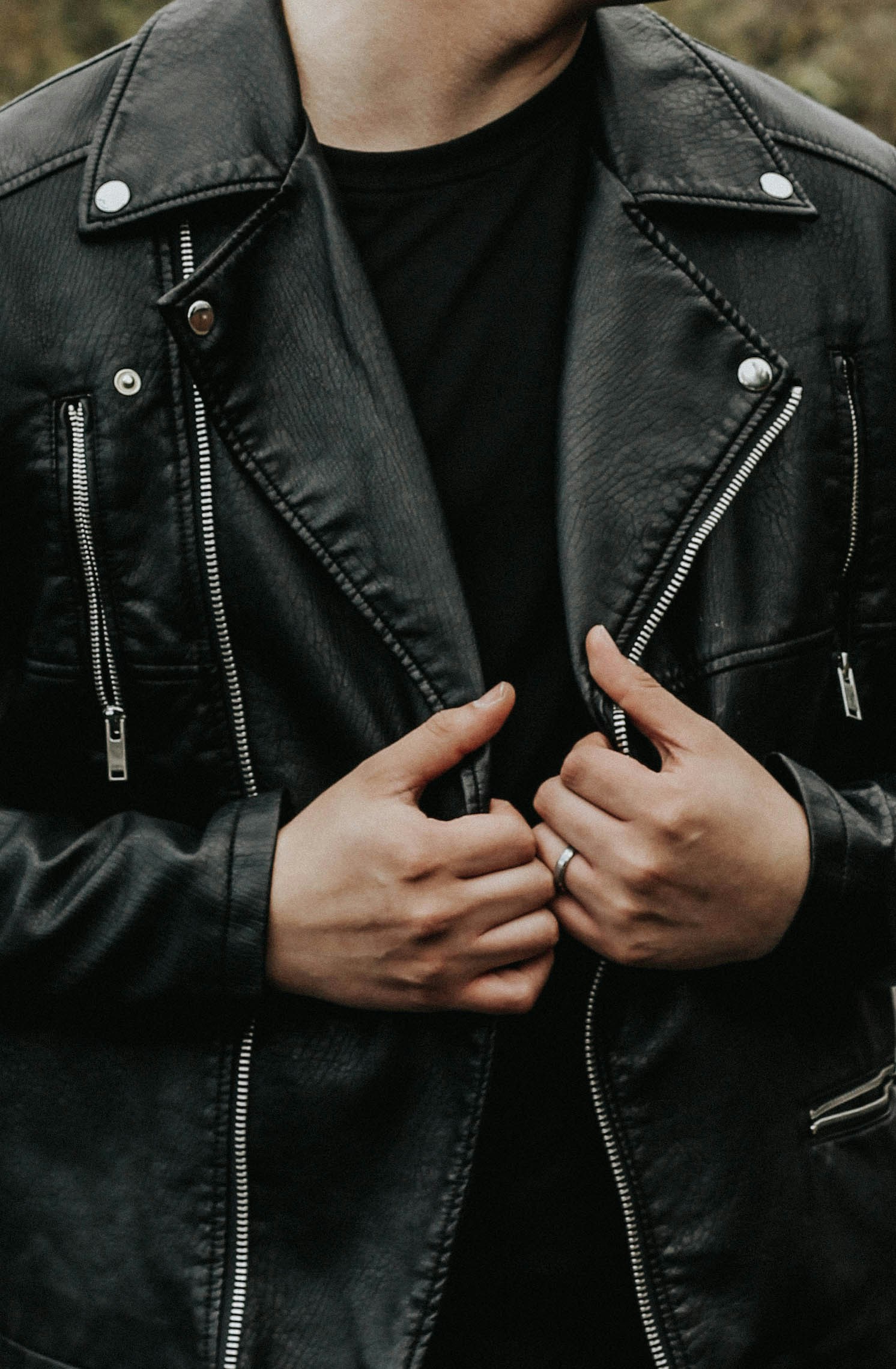 A closeup shot of a man holding his leather jacket | Source: Unsplash