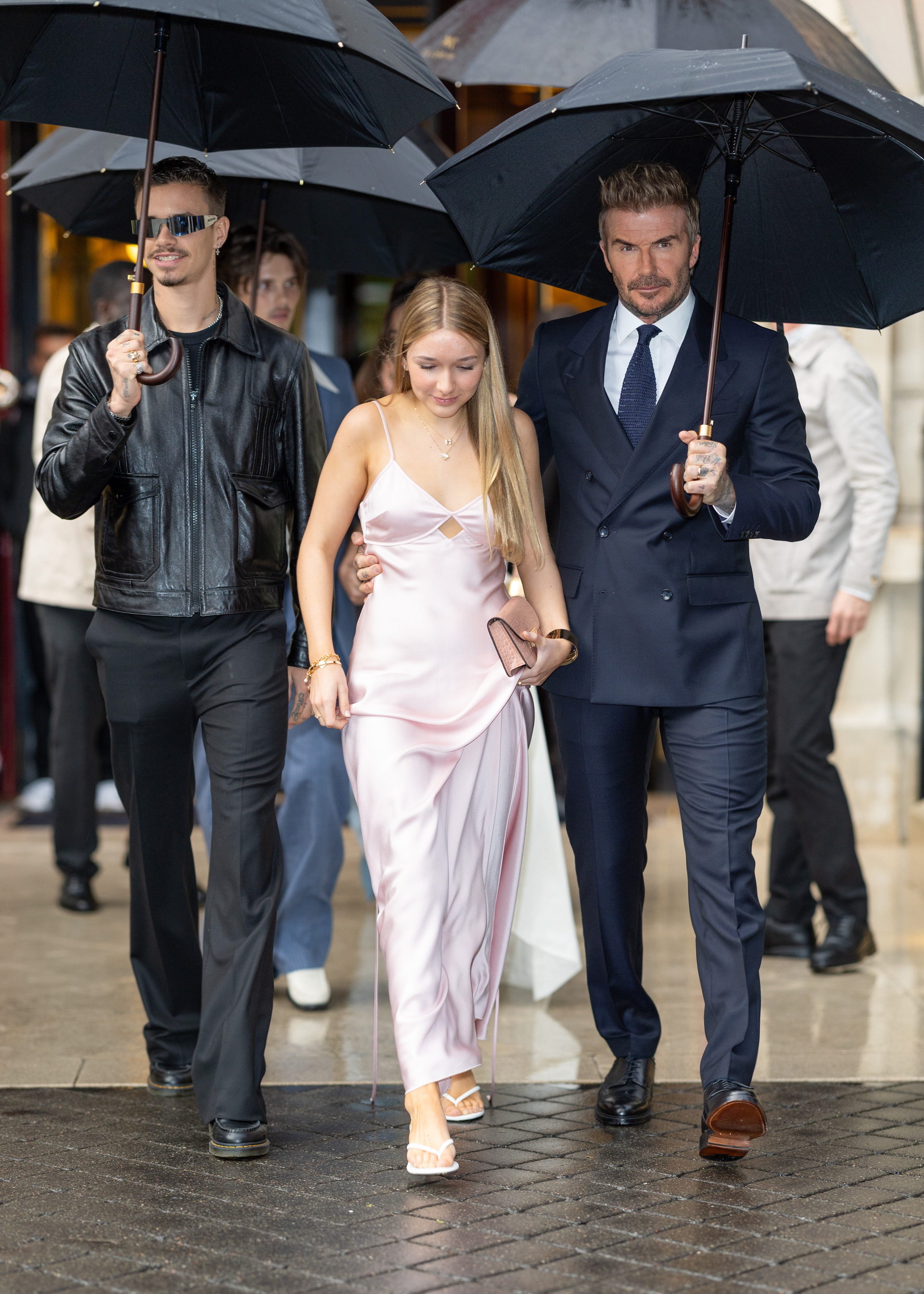 Romeo, Harper, and David Beckham walk together in Paris on September 27, 2024 | Source: Getty Images