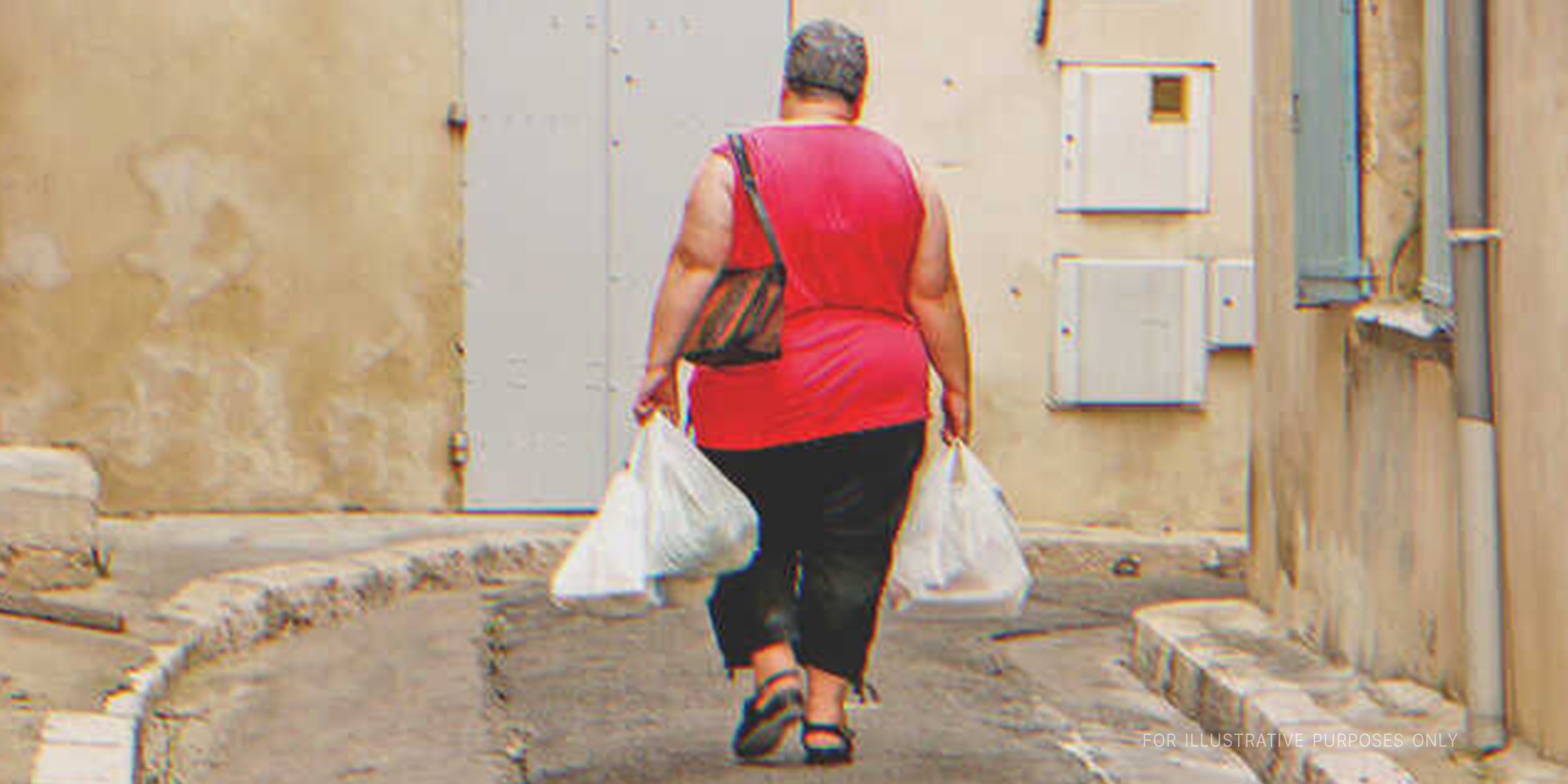 A woman carrying groceries. | Source: Shutterstock