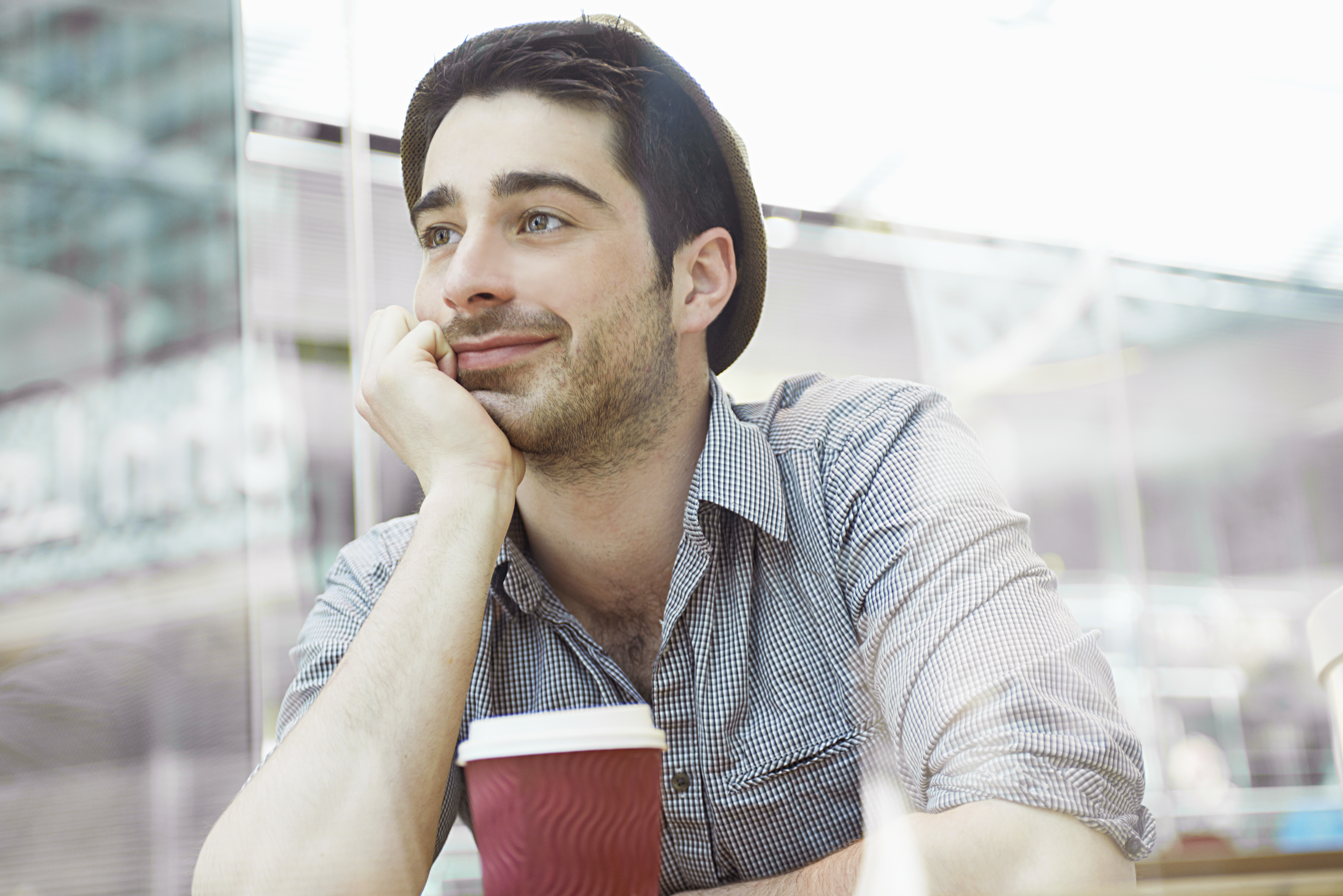 Man sitting in cafe with coffee | Source: Getty Images