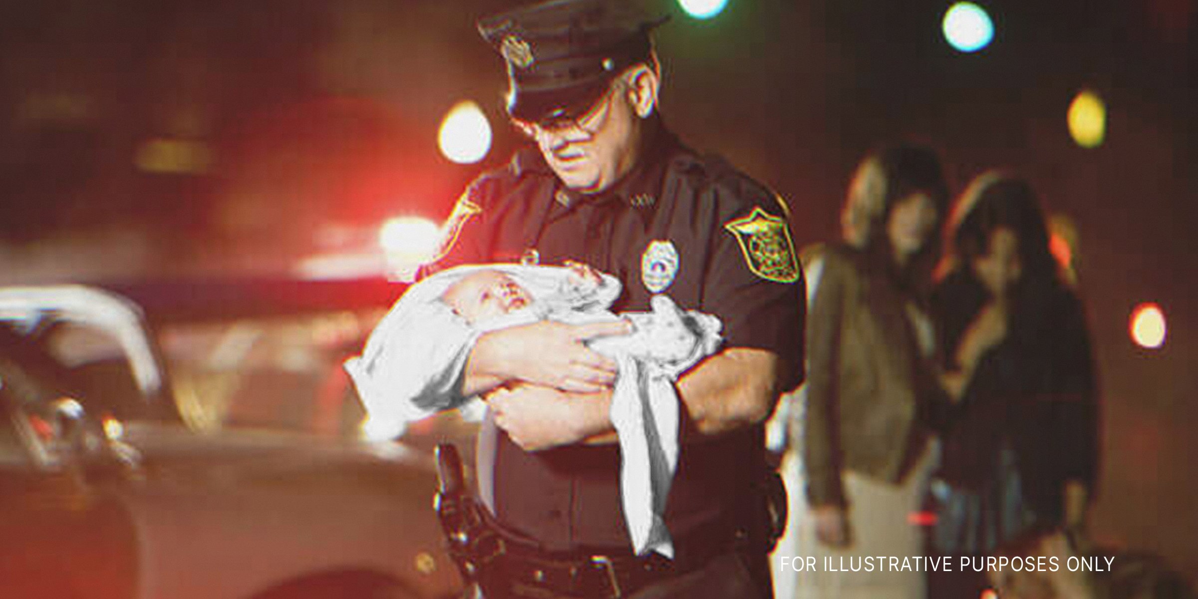 Cop holding baby. | Source: Getty Images