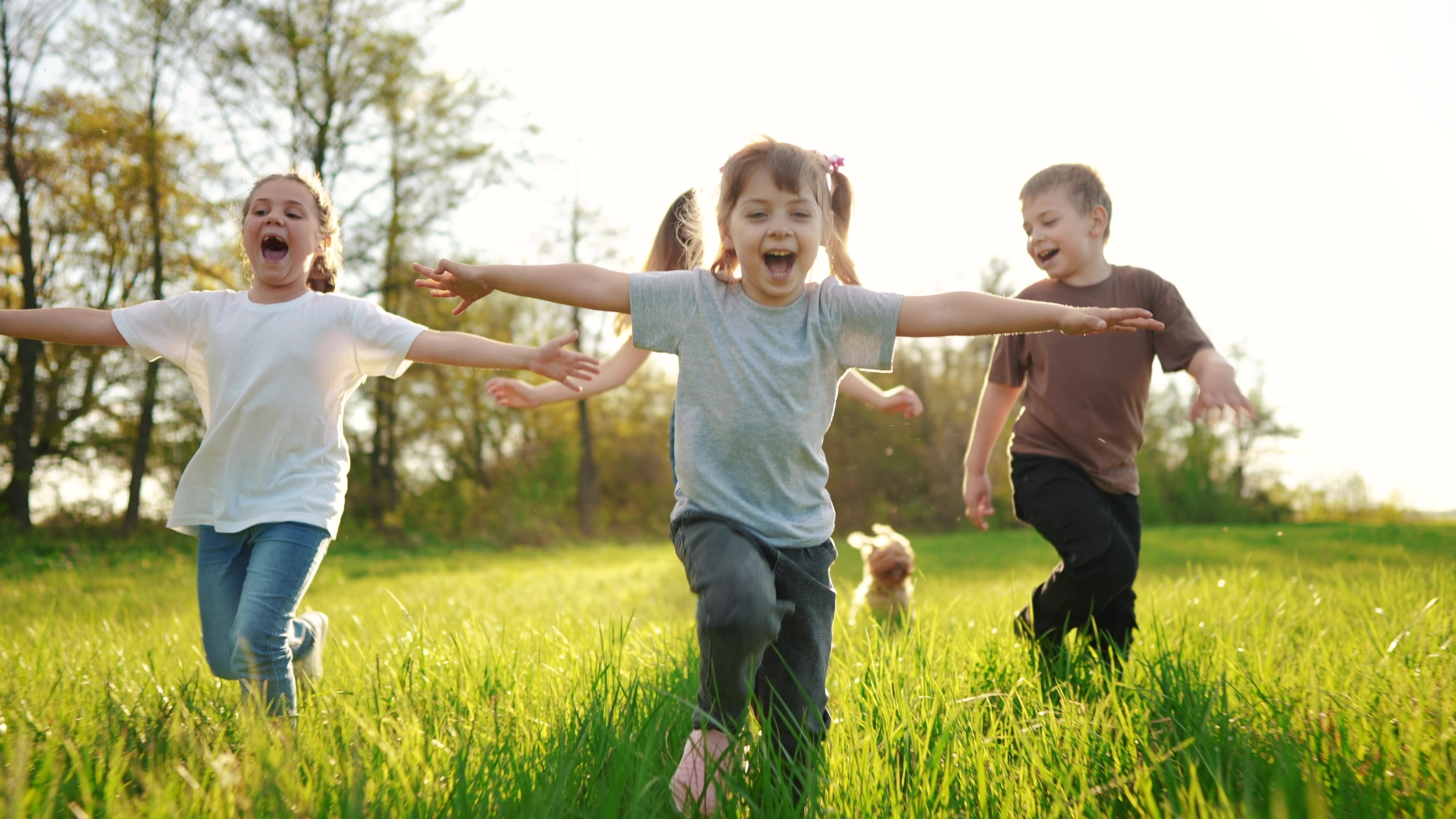 A group of happy young children are pictured having fun outside | Source: Shutterstock