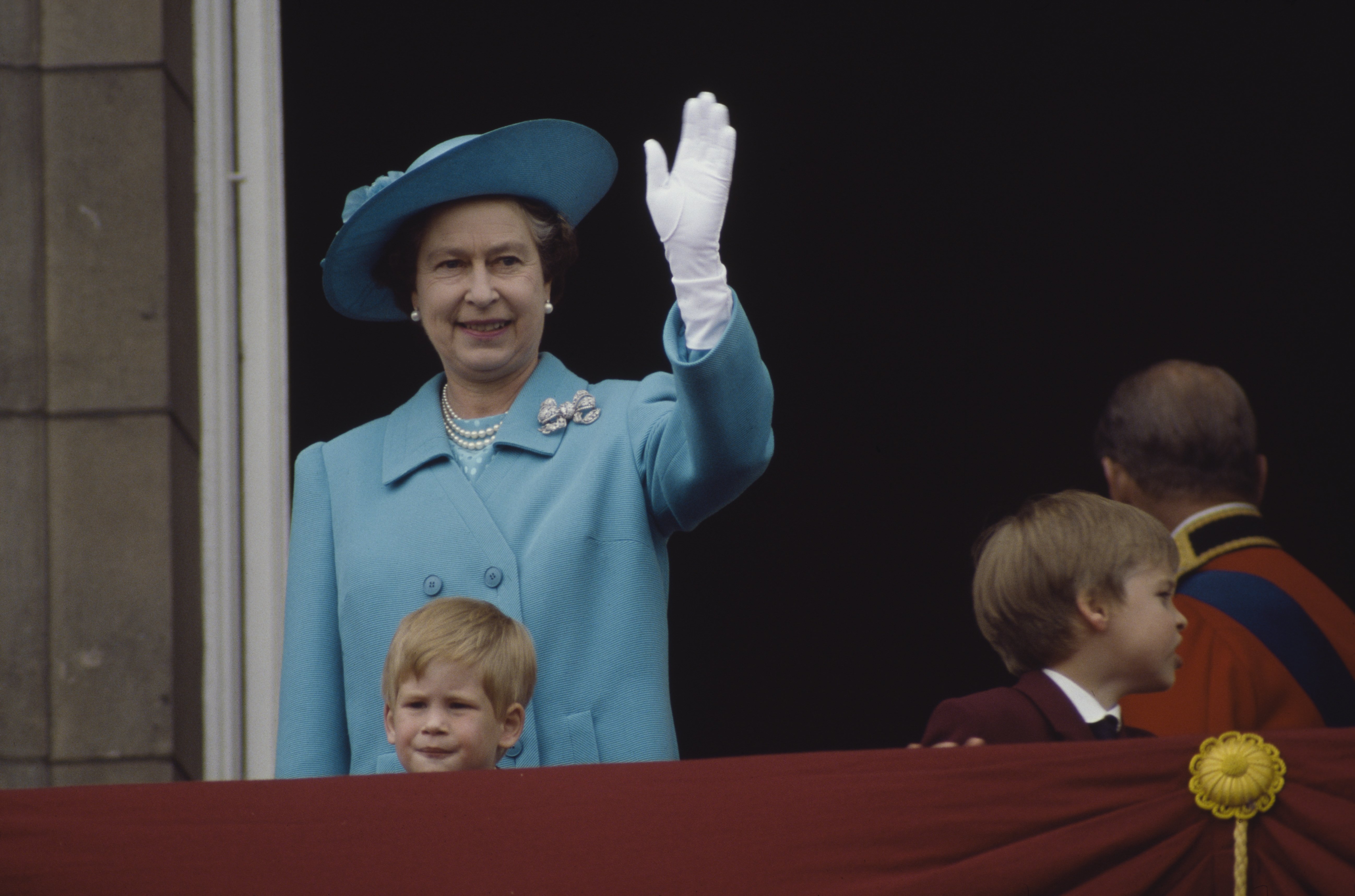 Queen Elizabeth II with Prince William and Prince Harry during the Trooping of the Color ceremony at Buckingham Palace in 1988 in London, England | Source: Getty Images