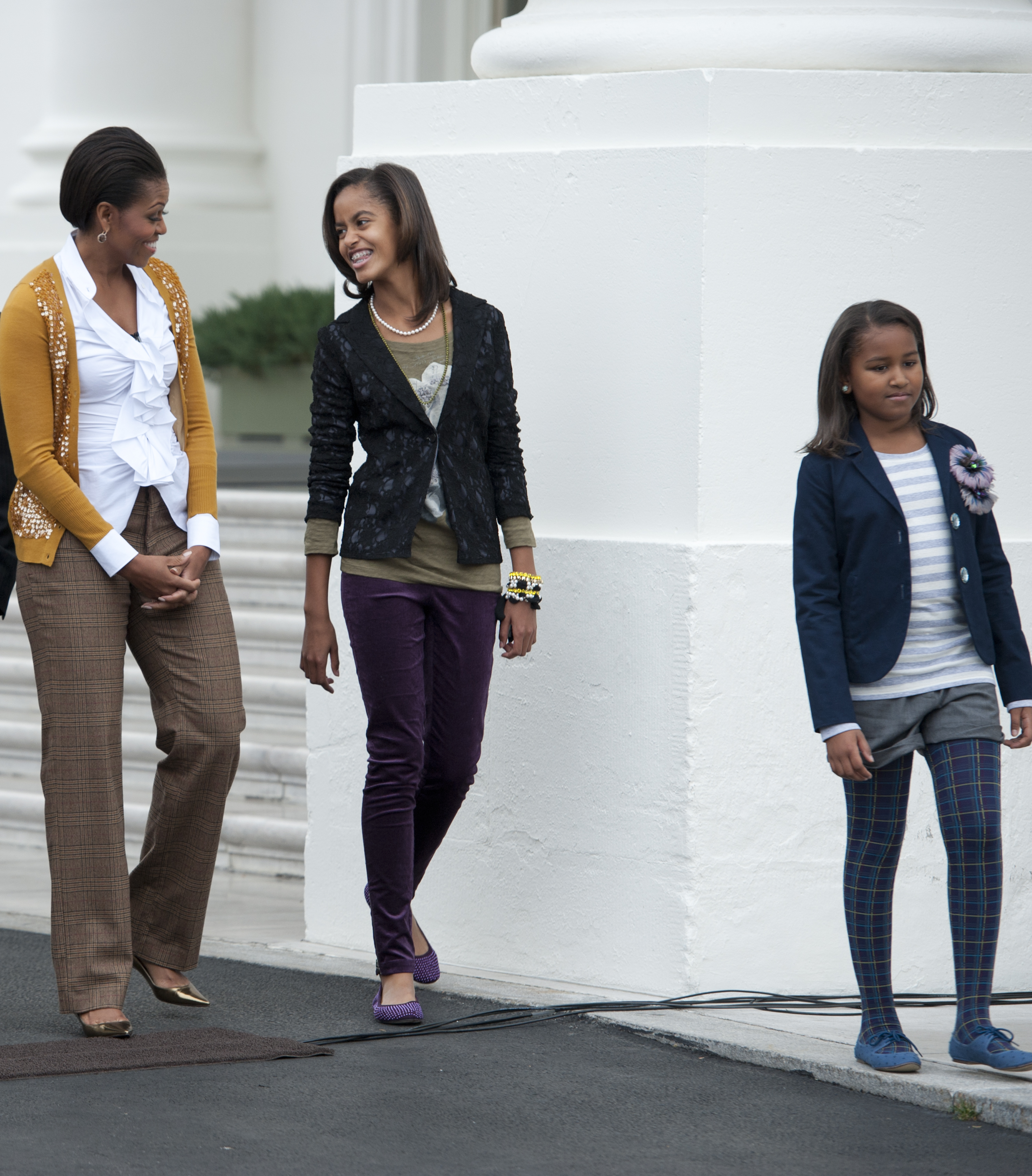 Michelle, Malia, and Sasha Obama walk along the North Portico of the White House in Washington, D.C. on November 26, 2010. | Source: Getty Images