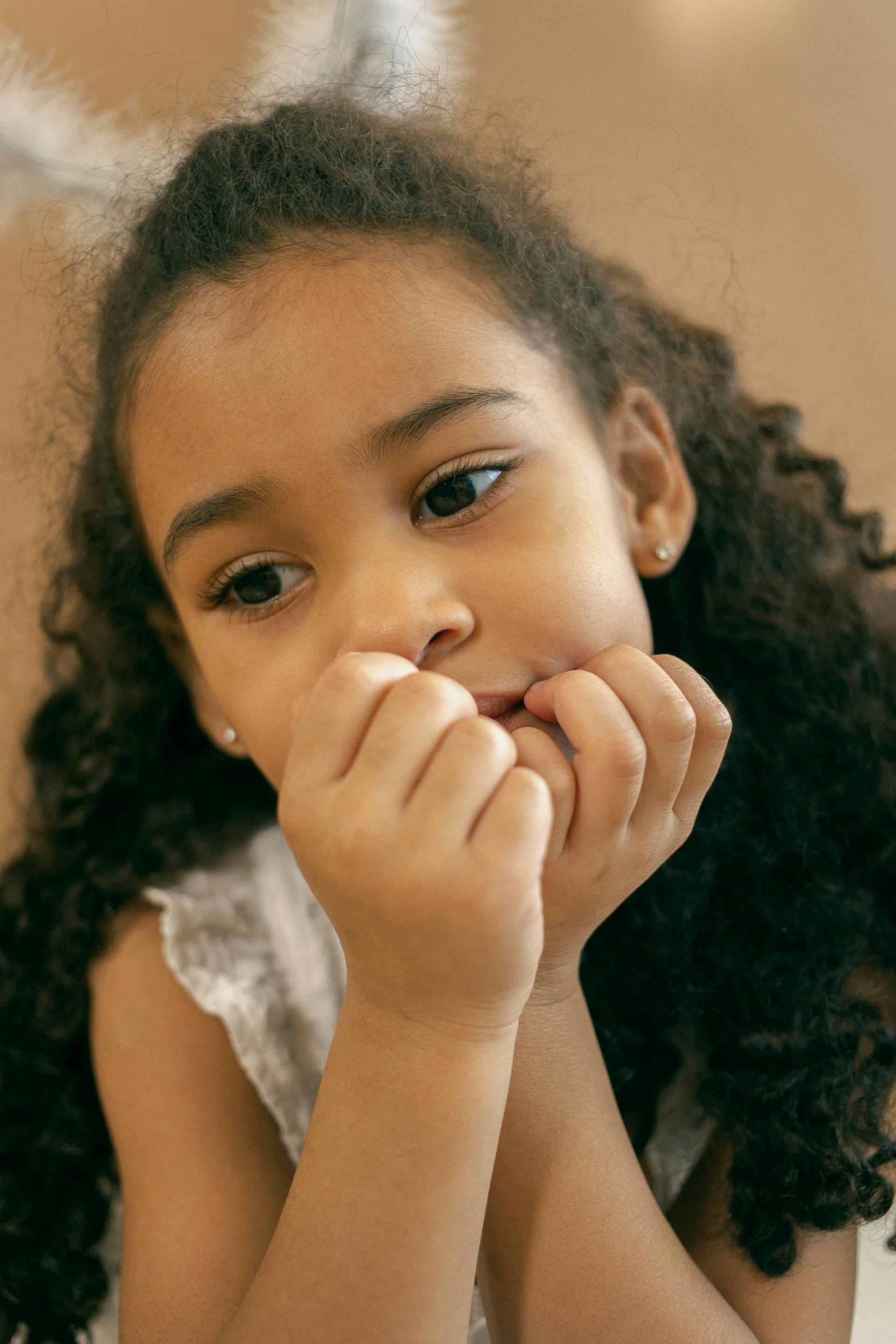 A little girl thinking about her room | Source: Pexels