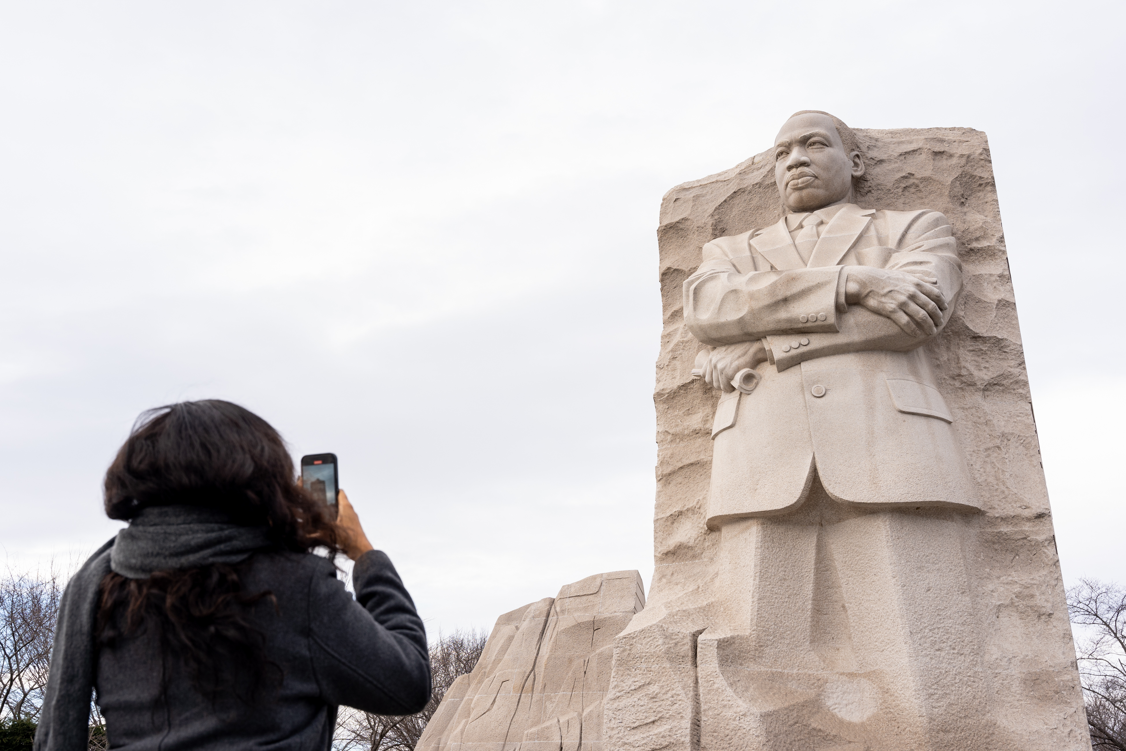 A person takes a photo of the Martin Luther King Jr. Memorial in Washington, D.C., on January 18, 2025 | Source: Getty Images