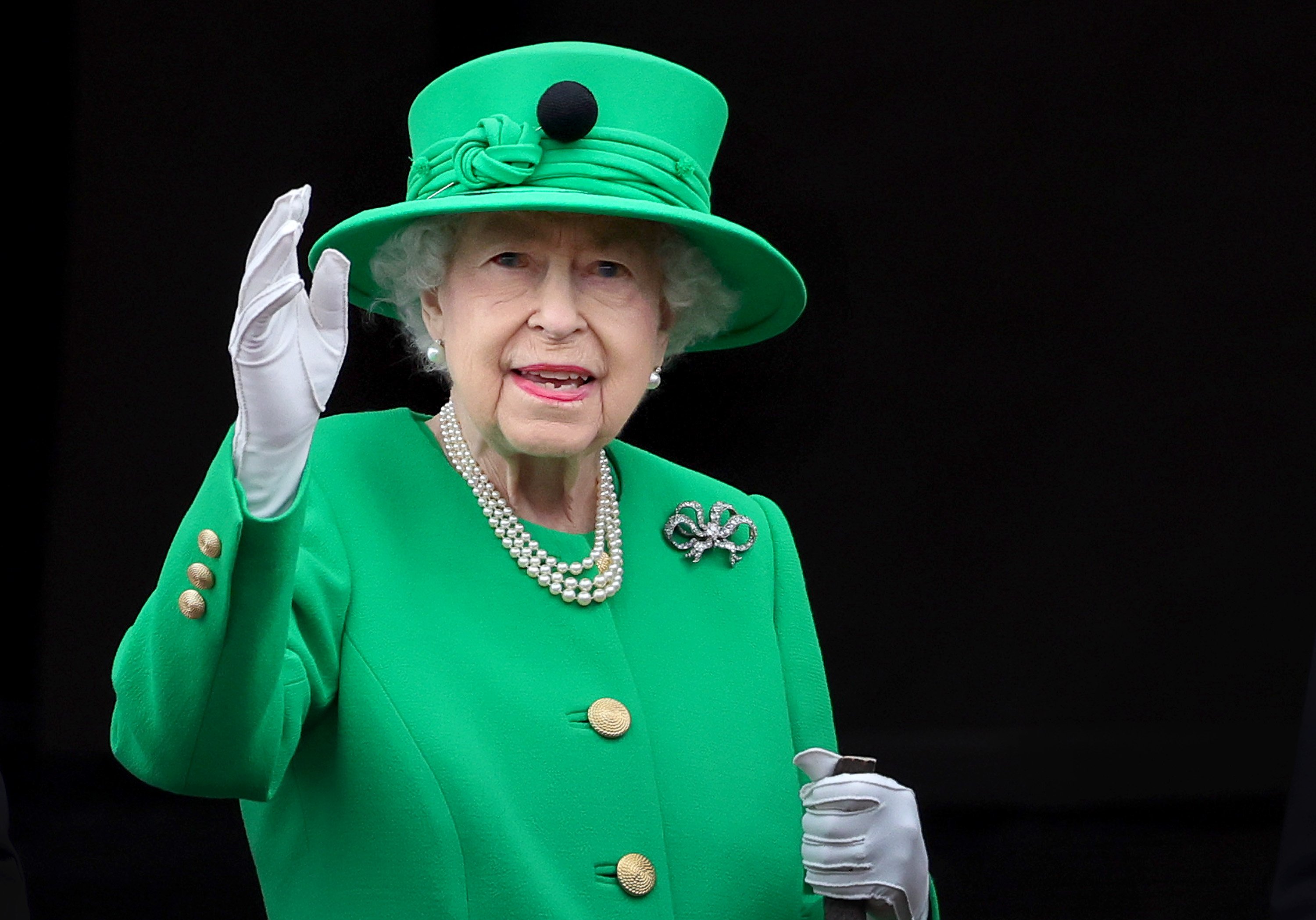 Queen Elizabeth II waves from the balcony of Buckingham Palace during the Platinum Jubilee Pageant on June 05, 2022 in London, England | Source: Getty Images