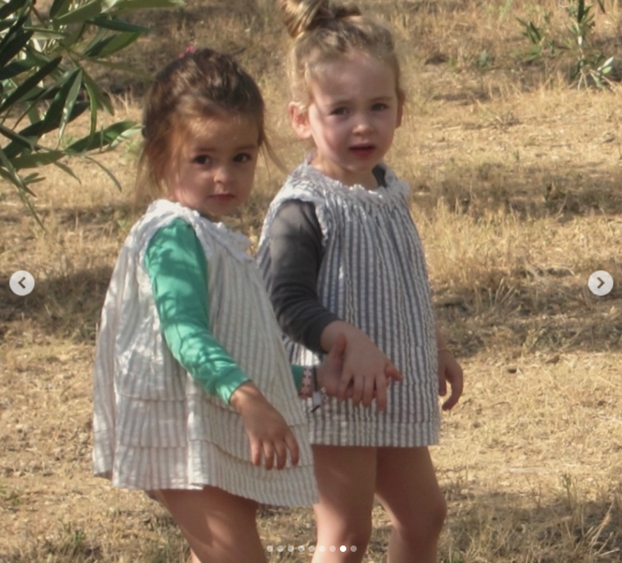 Tabitha and Marion hold hands while exploring a grassy landscape in another childhood photo Sarah Jessica Parker included in her birthday tribute. | Source: Instagram/sarahjessicaparker