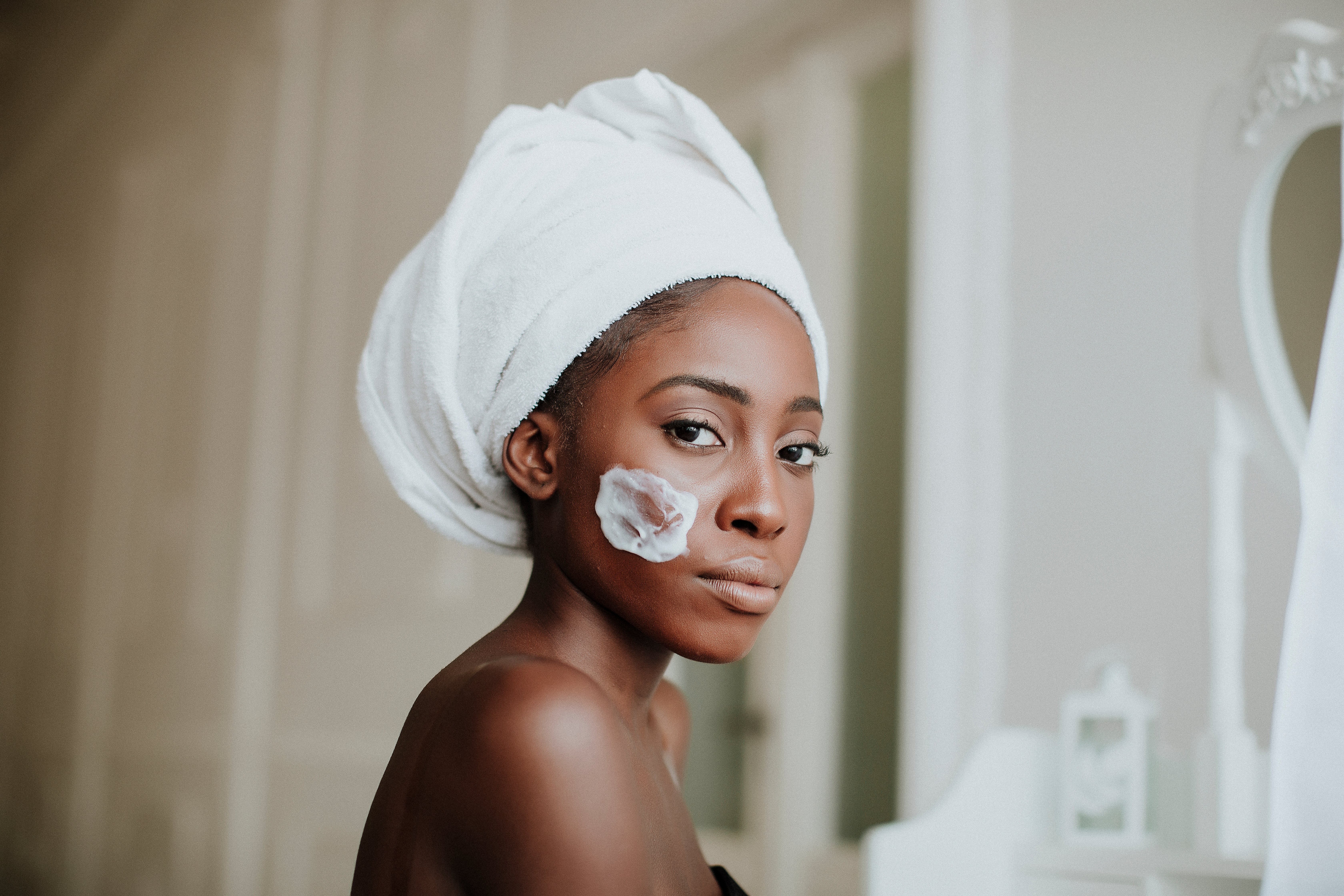  Portrait of beautiful young Afro-American woman taking care of her skin | Photo; Shutterstock