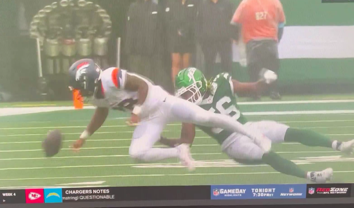 Tyler Badie falling to the ground after being hit by Quincy Williams during the Denver Broncos versus New York Jets game, posted on September 29, 2024 | Source: X/@jmthrivept