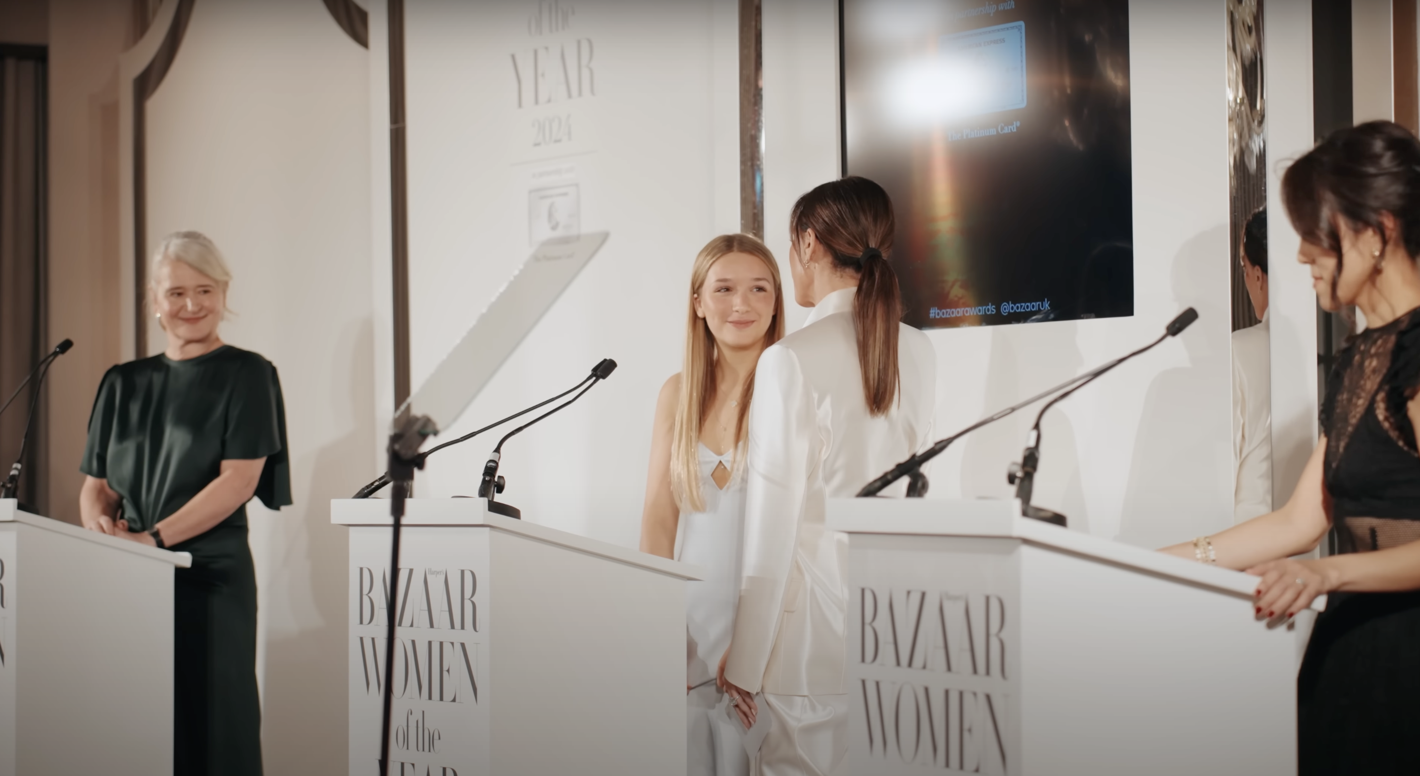 Harper and Victoria Beckham on-stage at the Harper's Bazaar's awards event, as seen in a video posted on November 7, 2024 | Source: YouTube/harpersbazaaruk