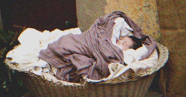 A newborn baby in a basket | Source: Shutterstock
