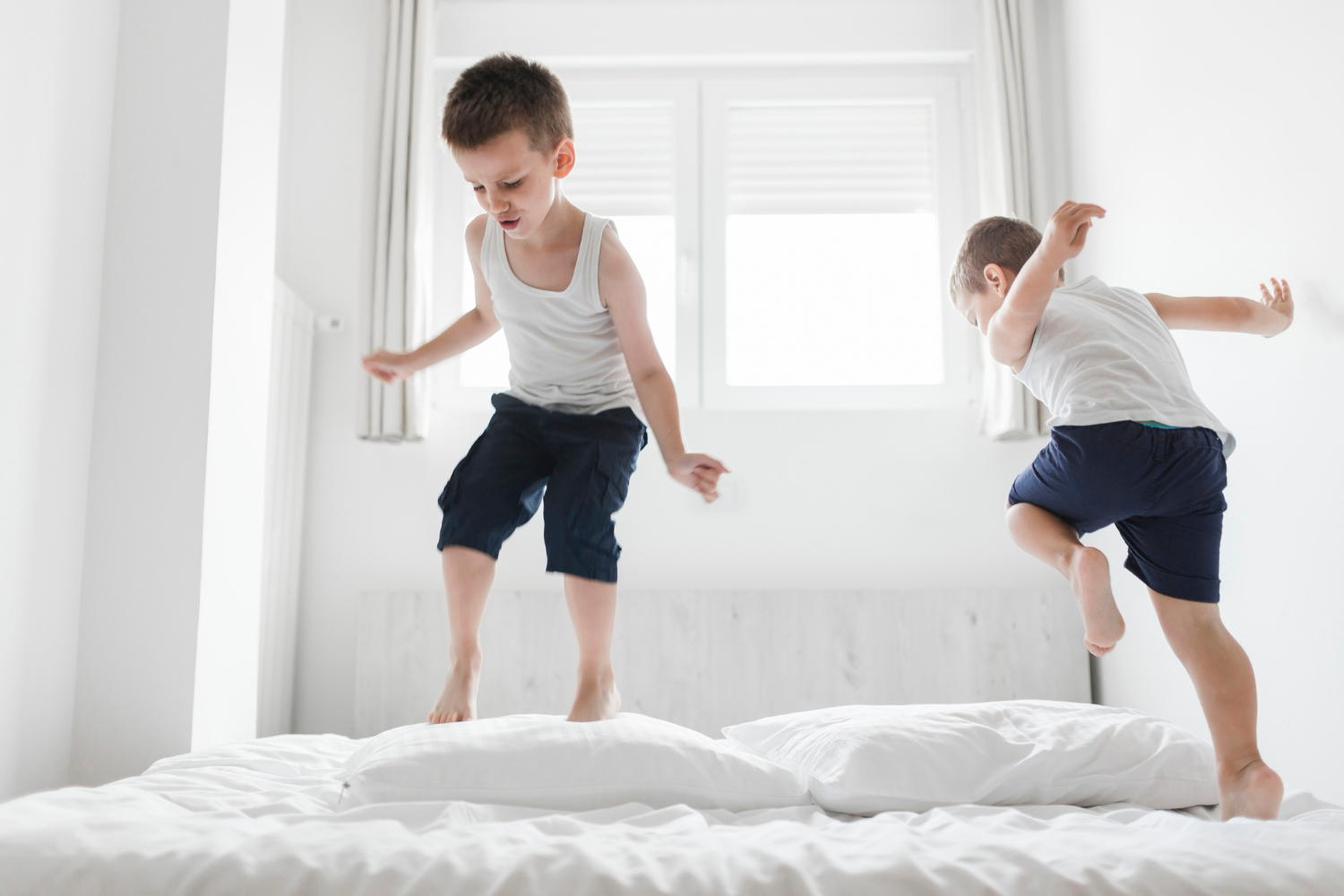Two boys jumping on the bed | Source: Freepik
