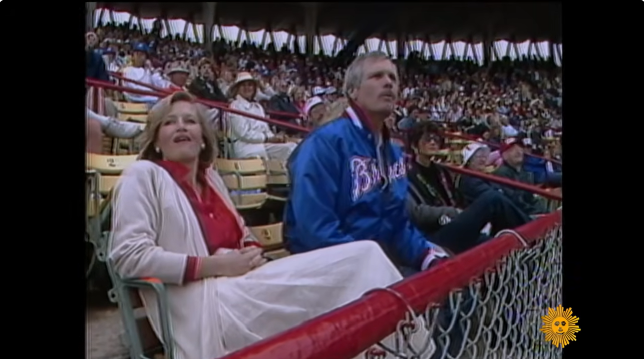 Ted Turner watches an Atlanta Braves game from the stands alongside actress Jane Fonda, during the era when his ownership helped turn the franchise into a national brand. | Source: YouTube/CBS Sunday Morning
