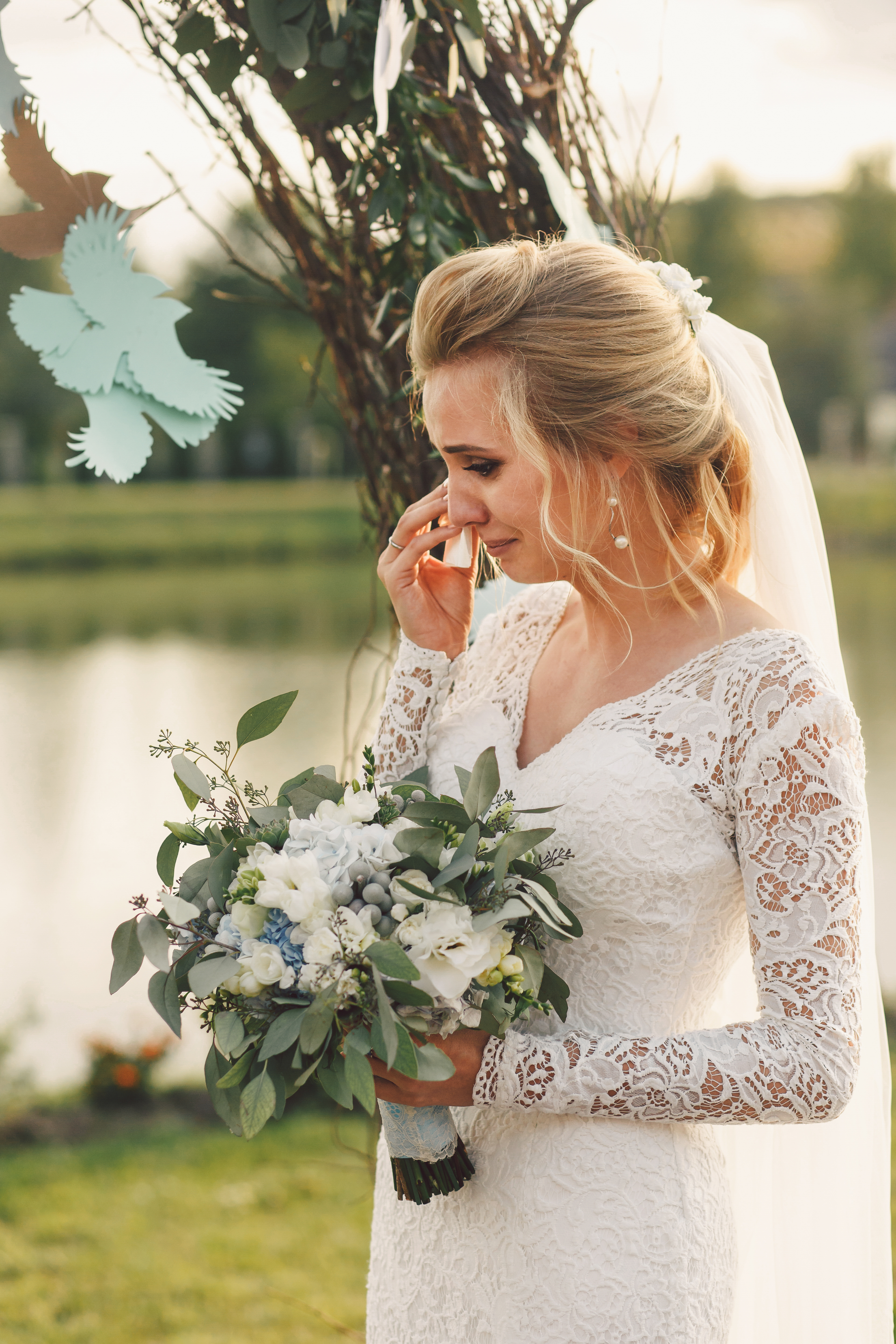 A bride crying while standing outdoors | Source: Shutterstock