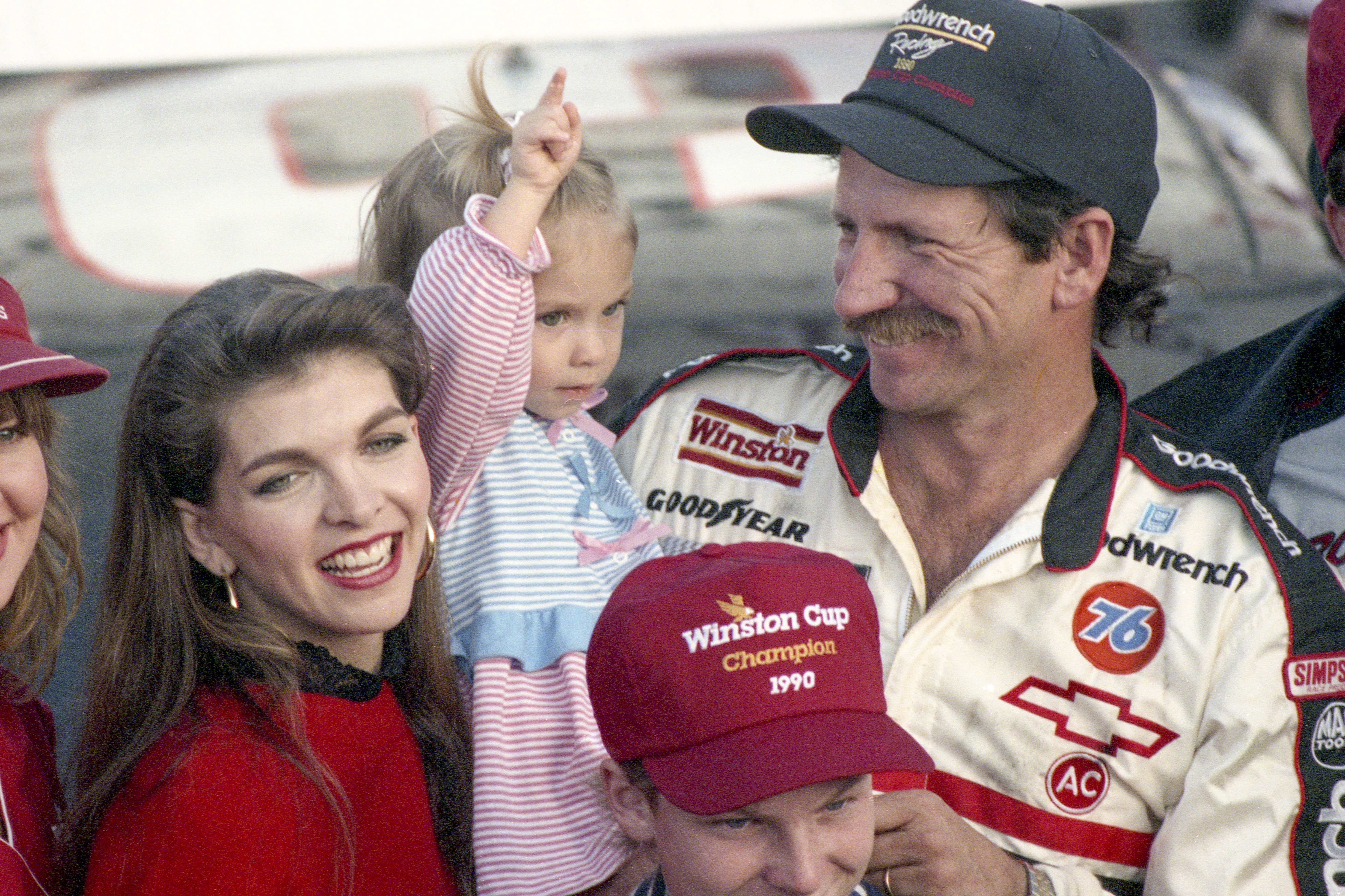 Dale Earnhardt celebrates his 4th NASCAR Winston Cup Championship with his wife and two of his children on November 18, 1990 | Source: Getty Images