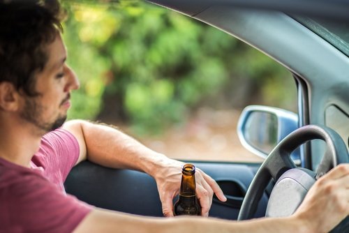 A man drinking and driving. | Source: Shutterstock.