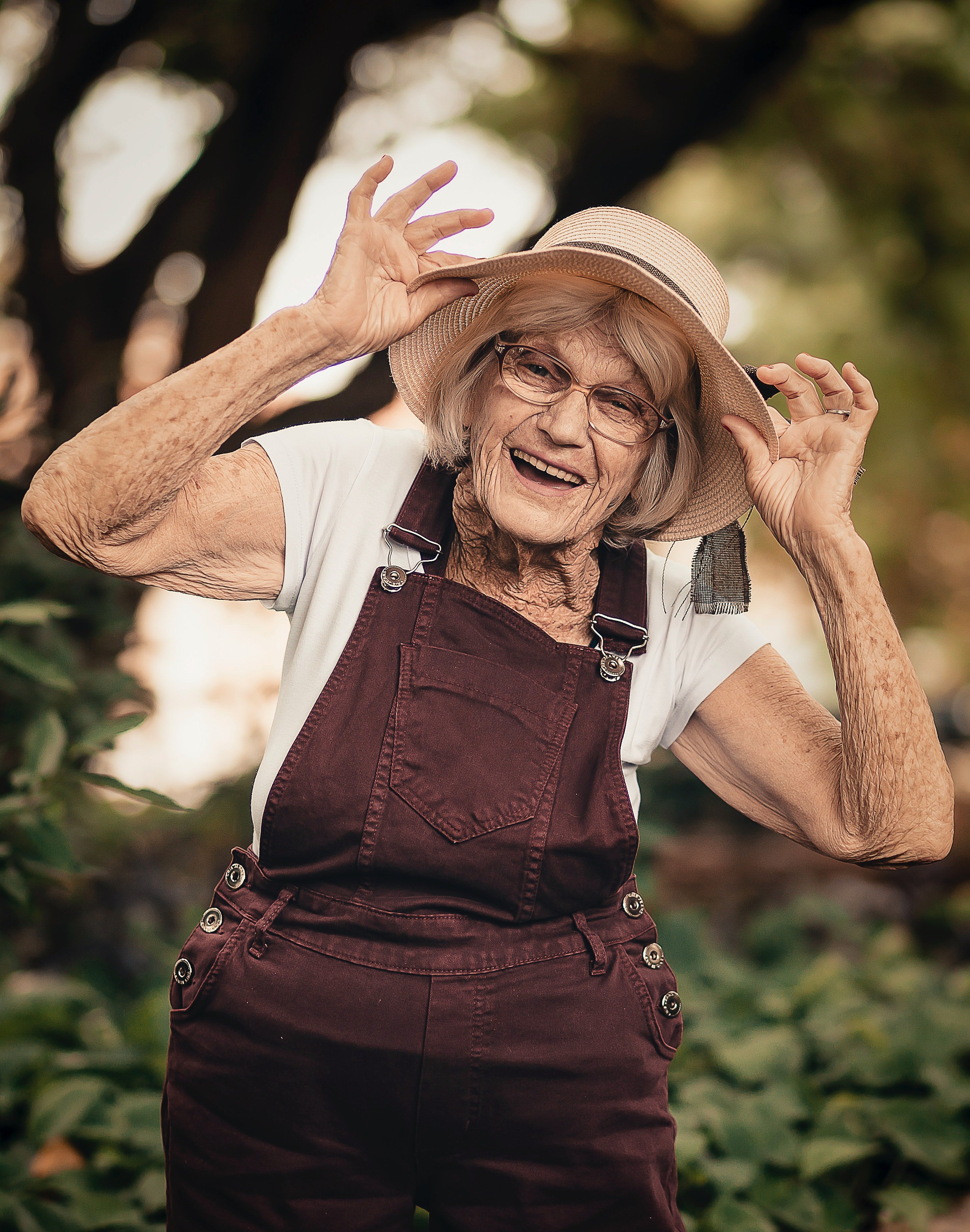 Pictured - An older woman posing near a green plant | Source: Pexels 