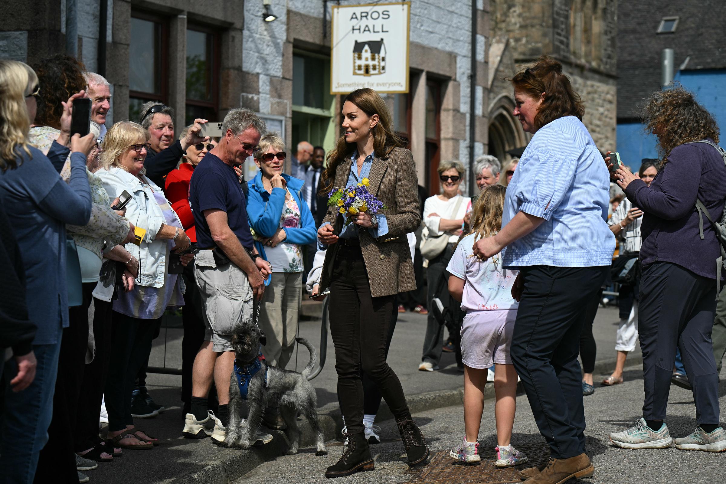 Outside Aros Hall, Catherine is seen greeting a crowd of smiling locals, holding a bright bouquet of flowers. The royals were warmly received as they connected with islanders during their two-day tour of Mull and Iona.