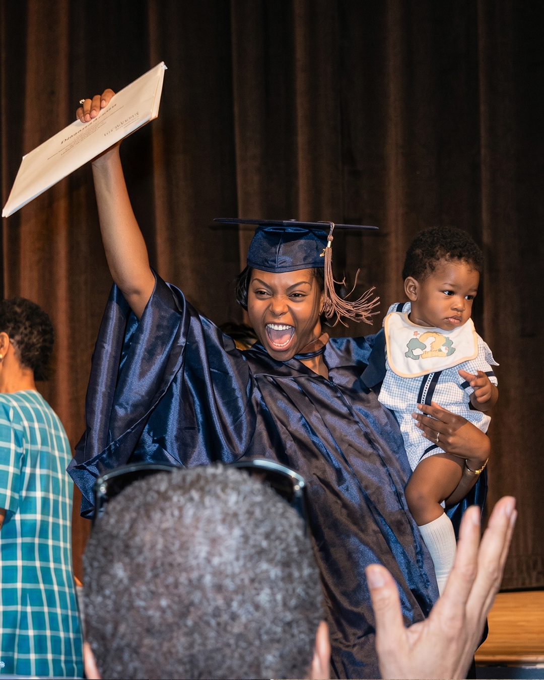 Taraji P. Henson holding her son on her graduation day; photo enhanced by Gemini, posted on July 10, 2020. | Sources: Facebook/Taraji P. Henson | Gemini