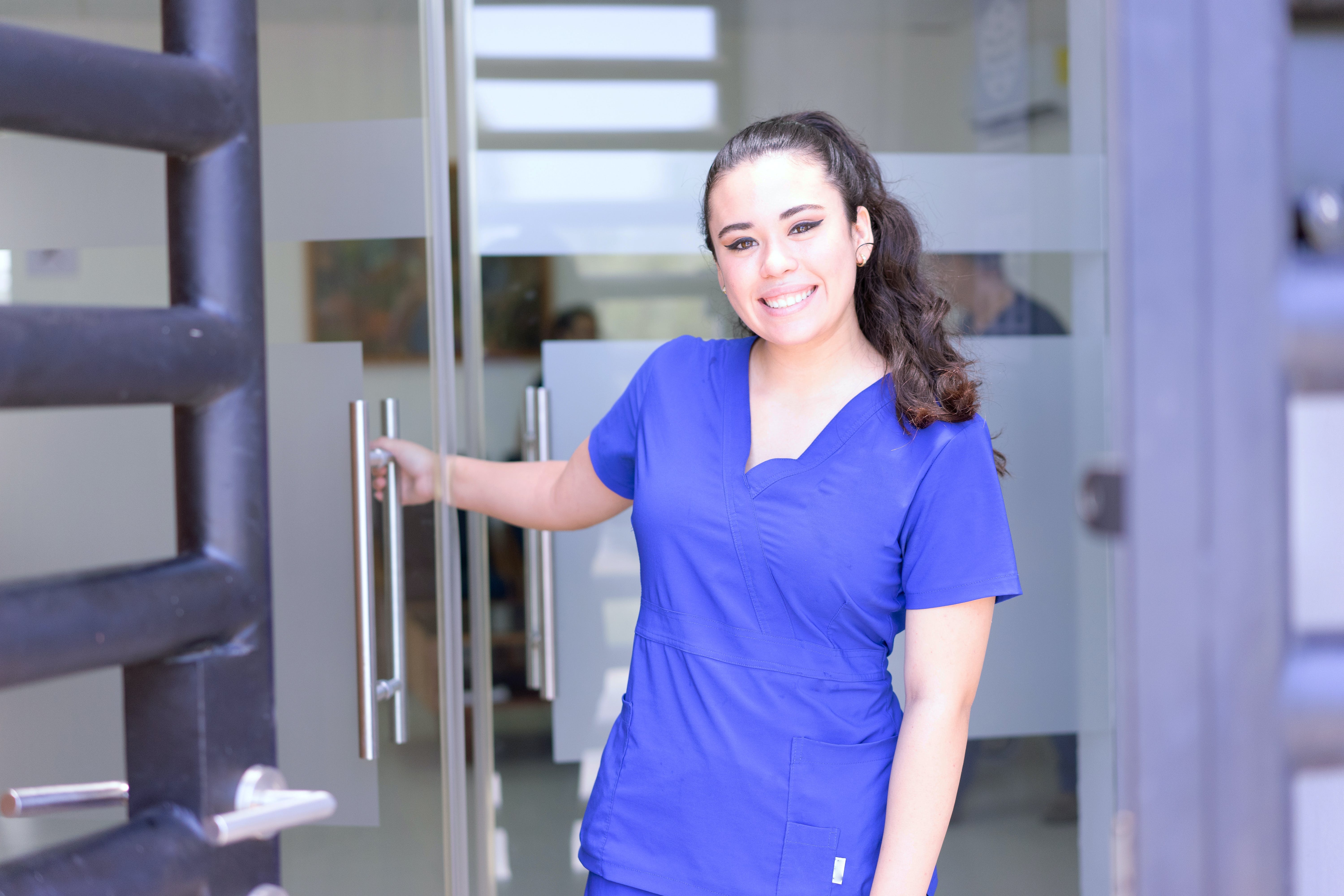 A woman in scrub suit smiling | Source: Pexels
