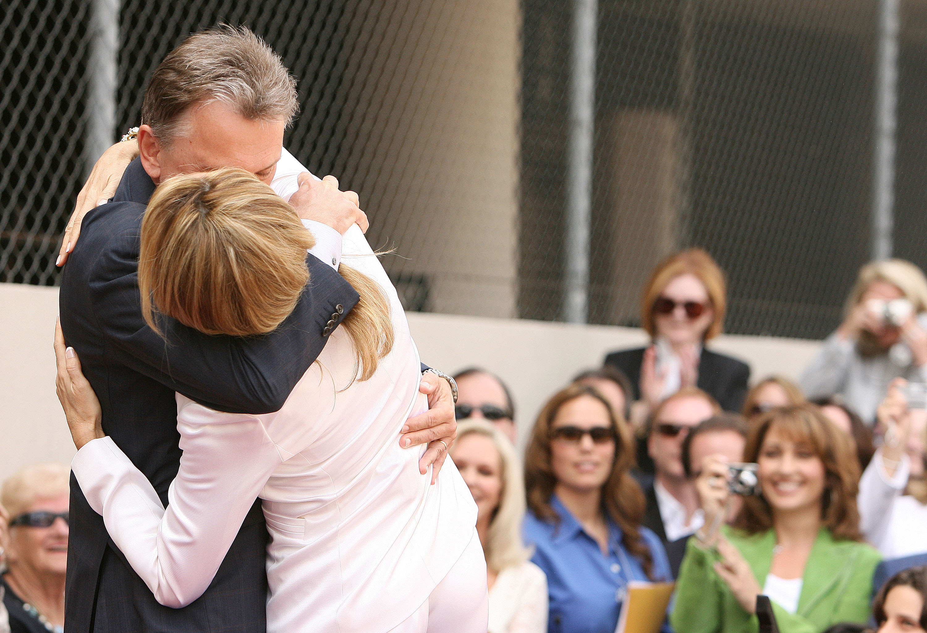 Pat Sajak embraces Vanna White during her honor ceremony, where she received a Star on the Hollywood Walk of Fame in California, 2006 | Source: Getty Images