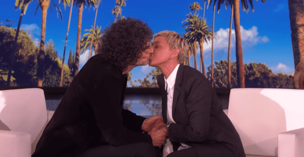 Howard Stern and Ellen DeGeneres kiss during his appearance on the Ellen Show. | Source: YouTube/TheEllenShow