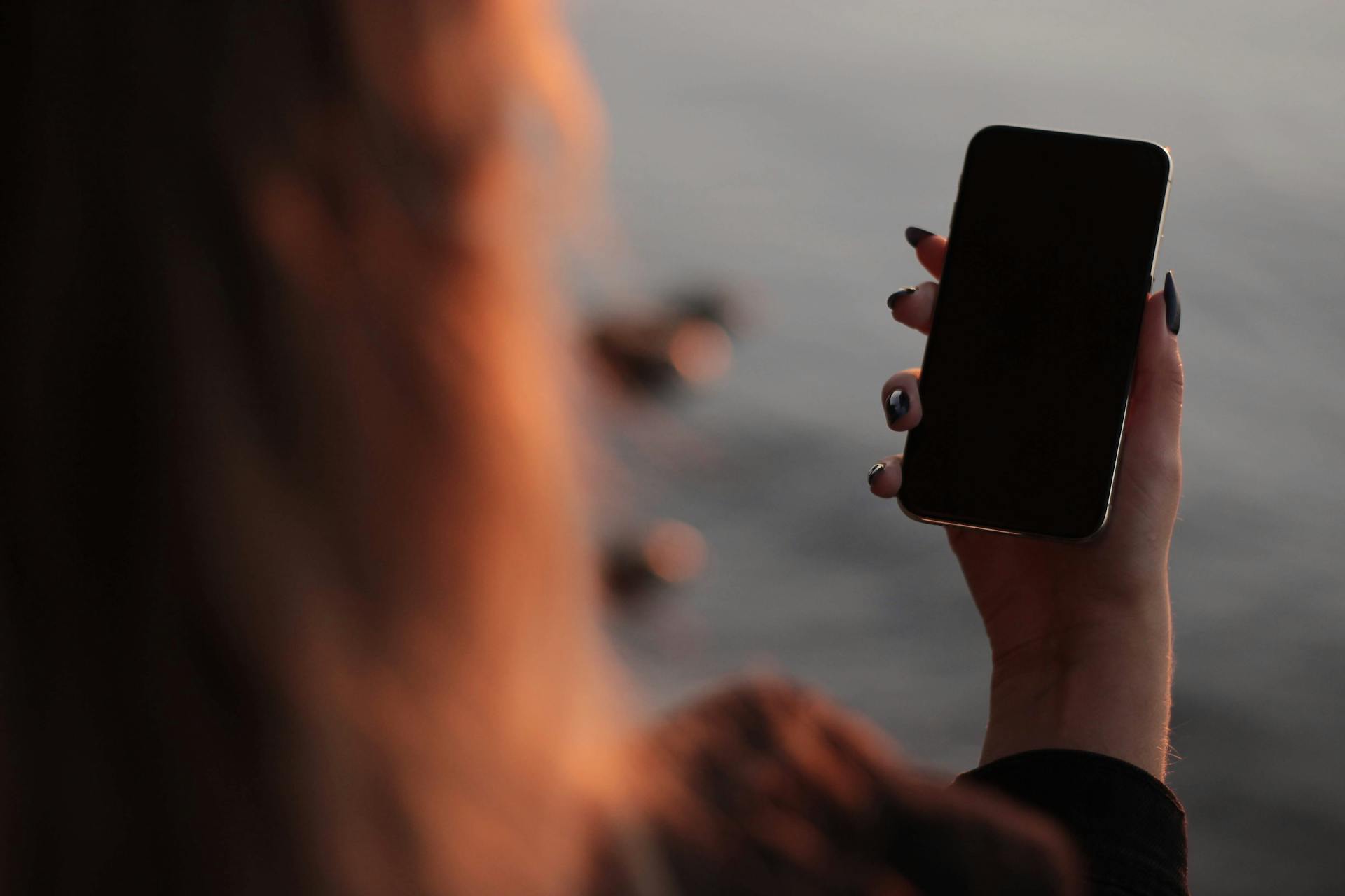 A woman holding a phone | Source: Pexels