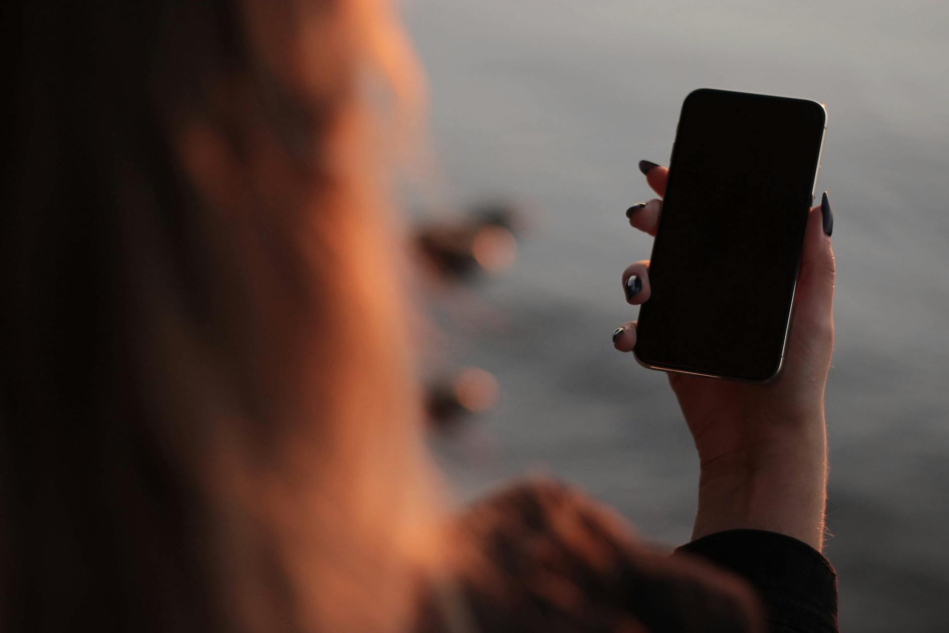 Woman checking out a phone | Source: Pexels