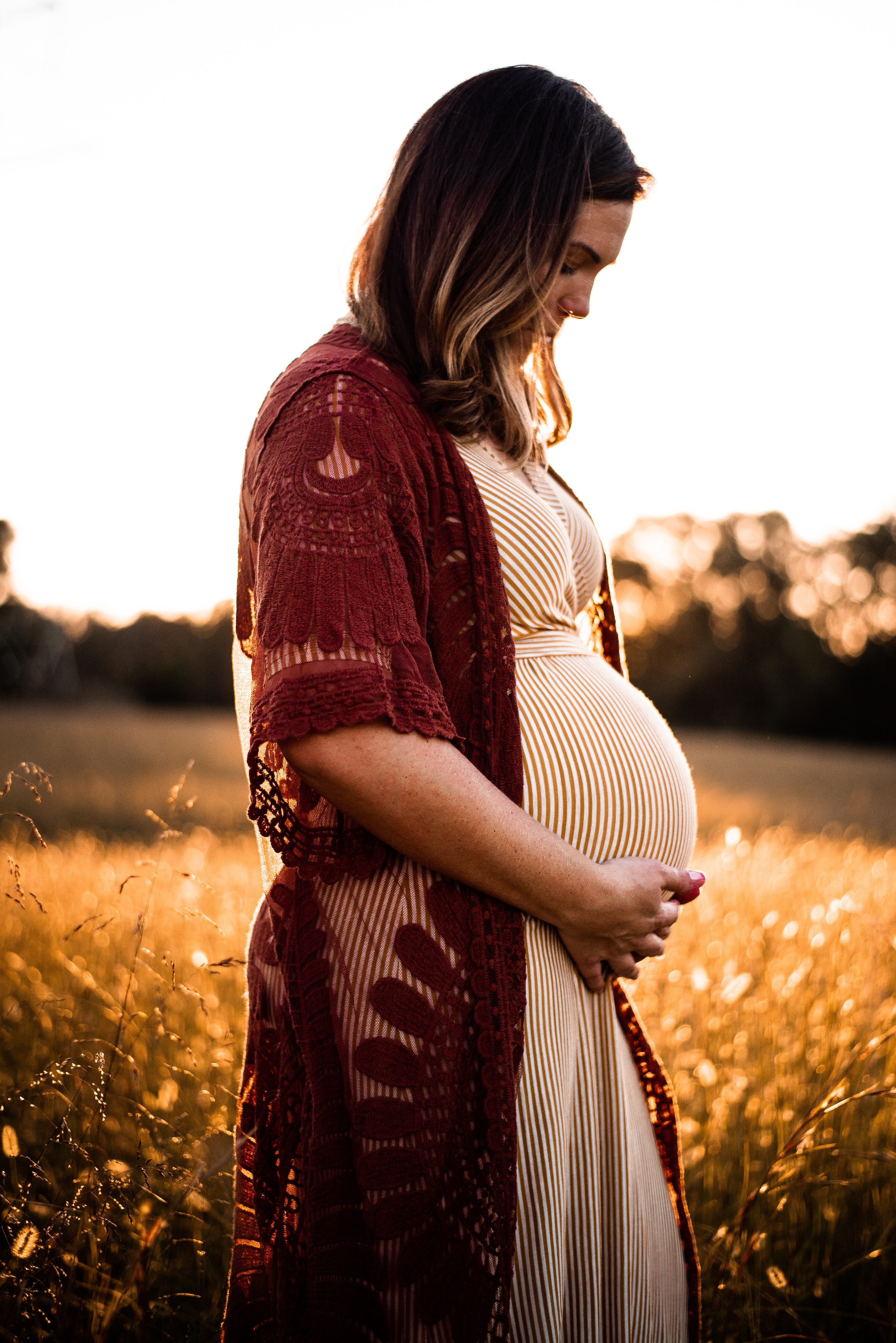 A pregnant woman holding her baby bump | Source: Unsplash