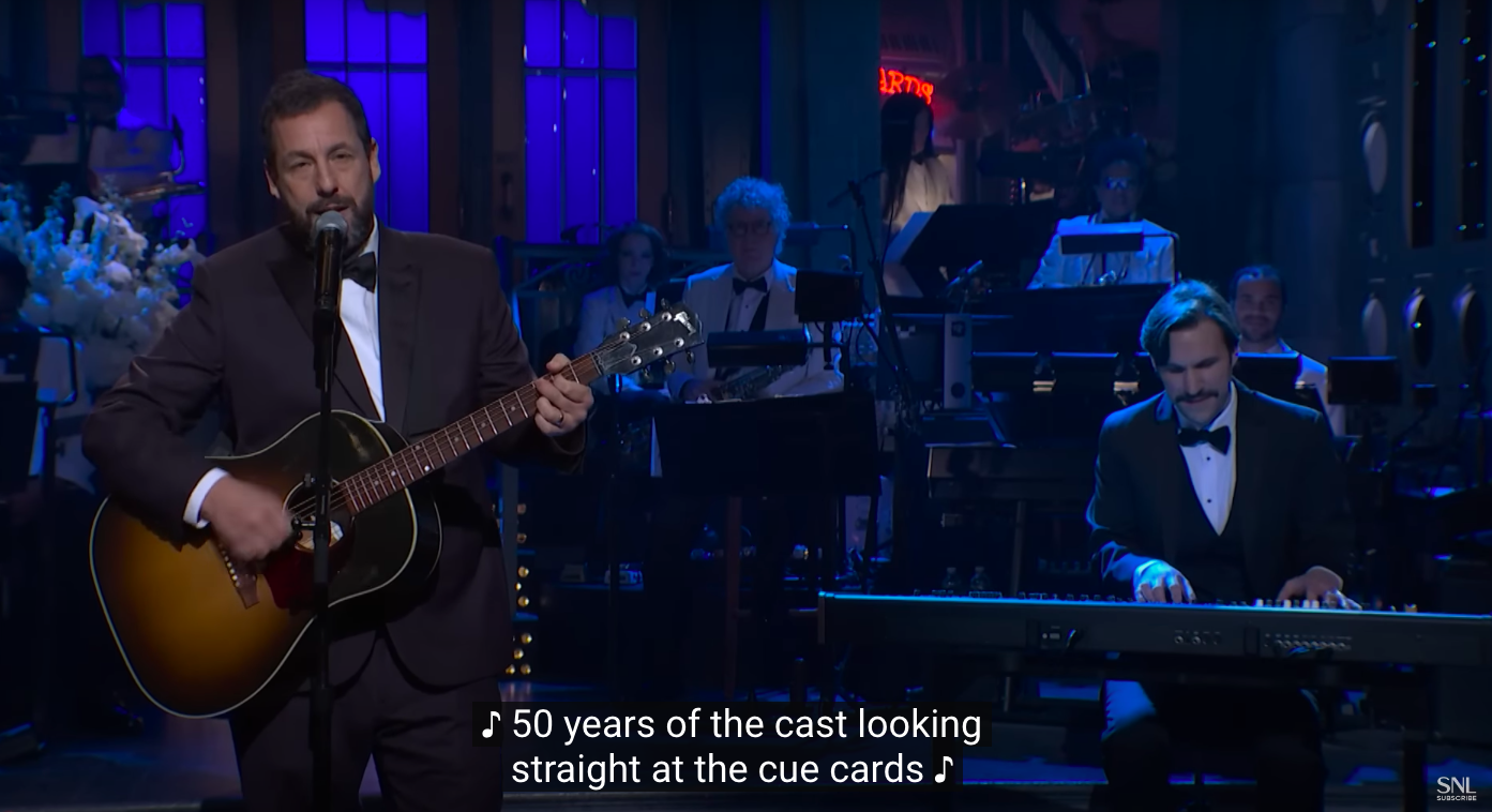 Adam Sandler singing with the accompaniment of a live band. | Source: YouTube/Saturday Night Live