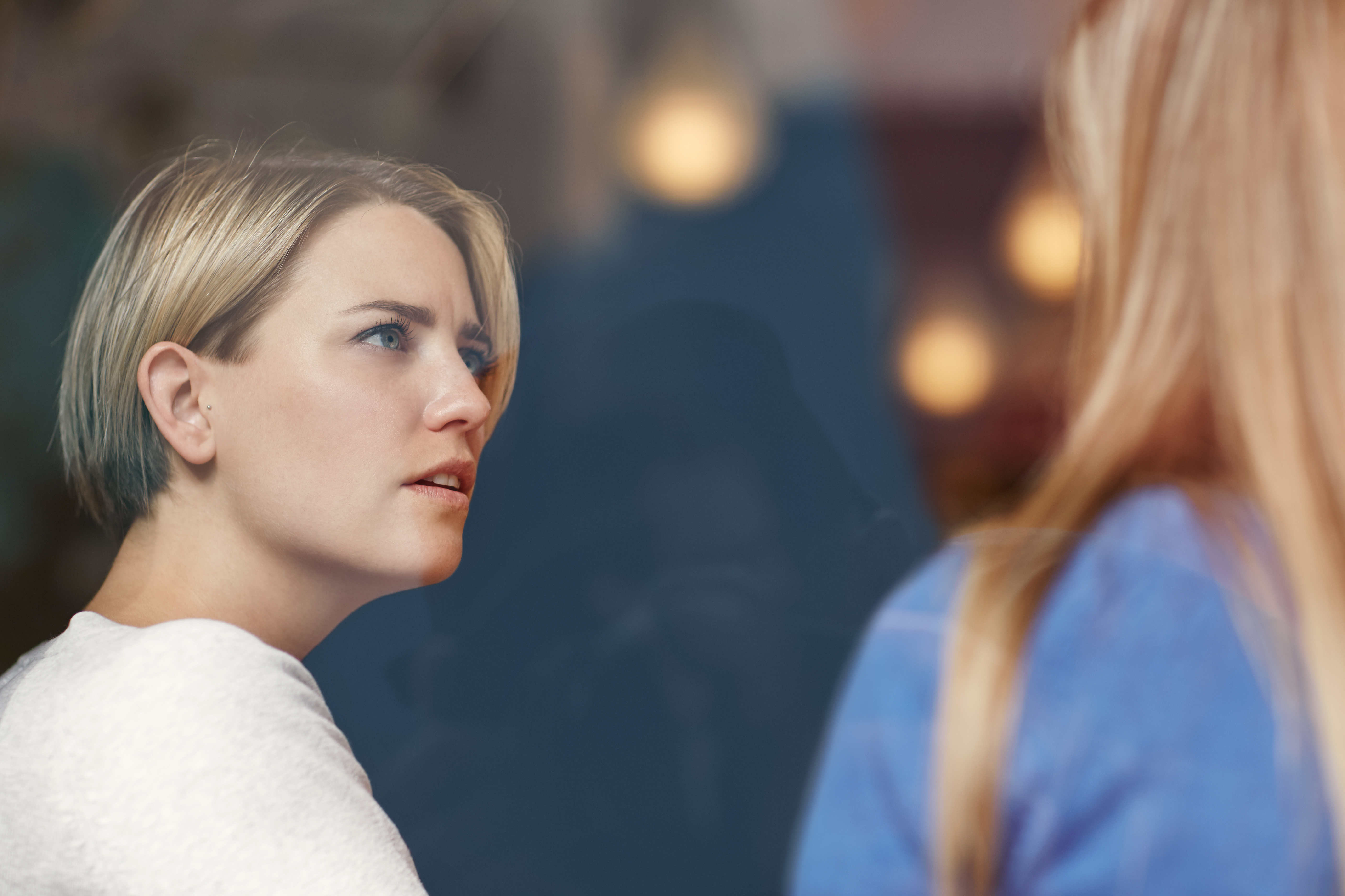 Woman looking shocked while listening to another woman | Source: Shutterstock