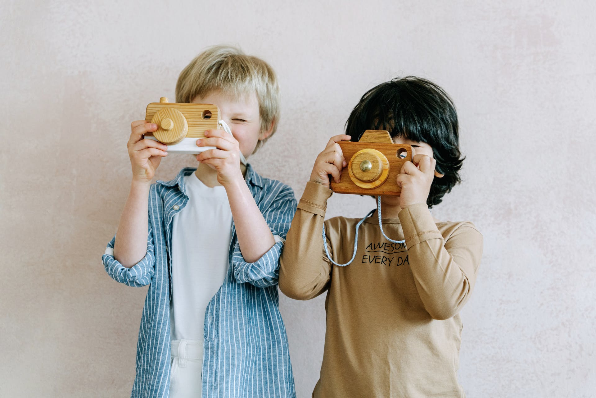 Two boys playing with toy camera | Source: Pexels
