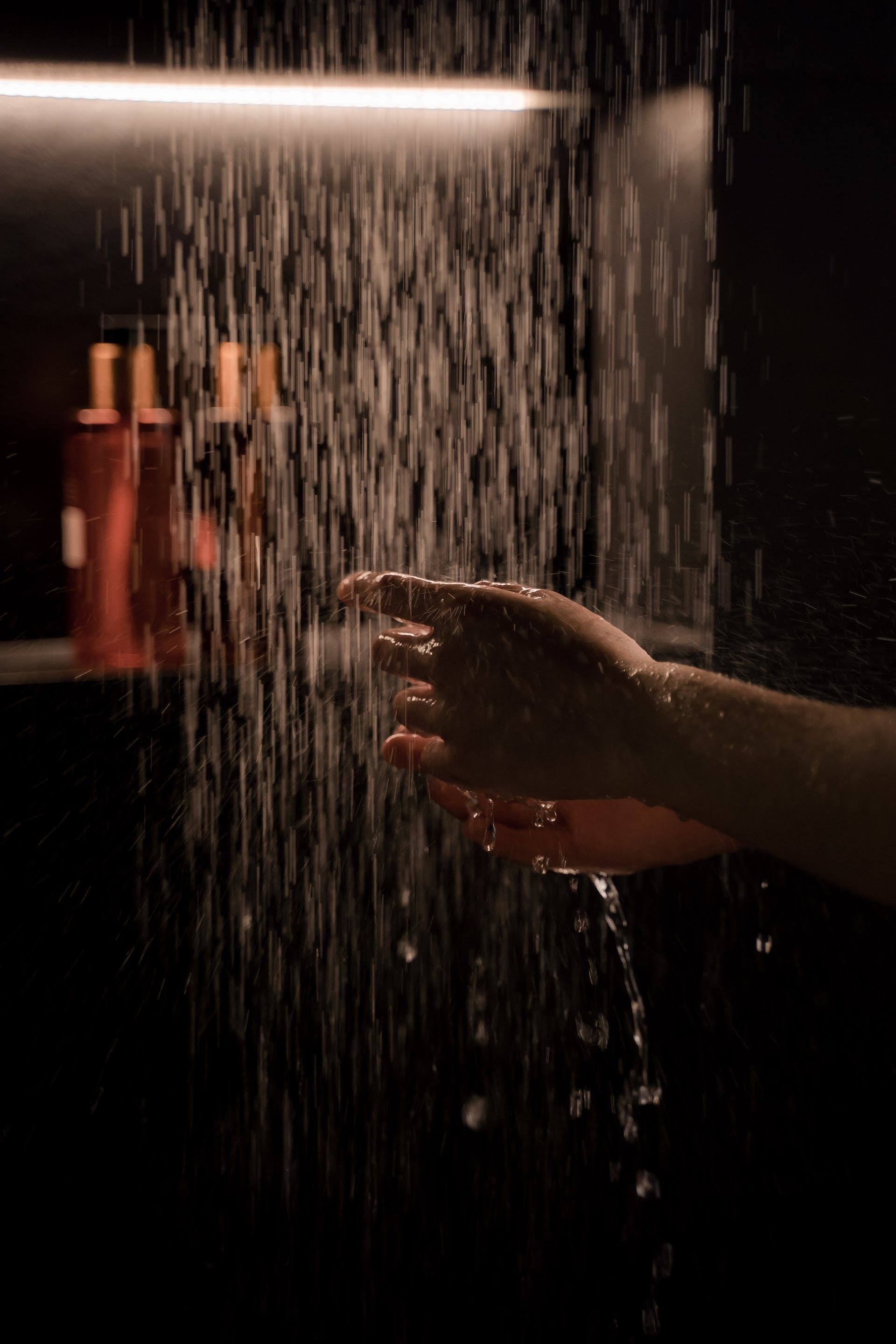 A person's hand under a shower | Source: Pexels