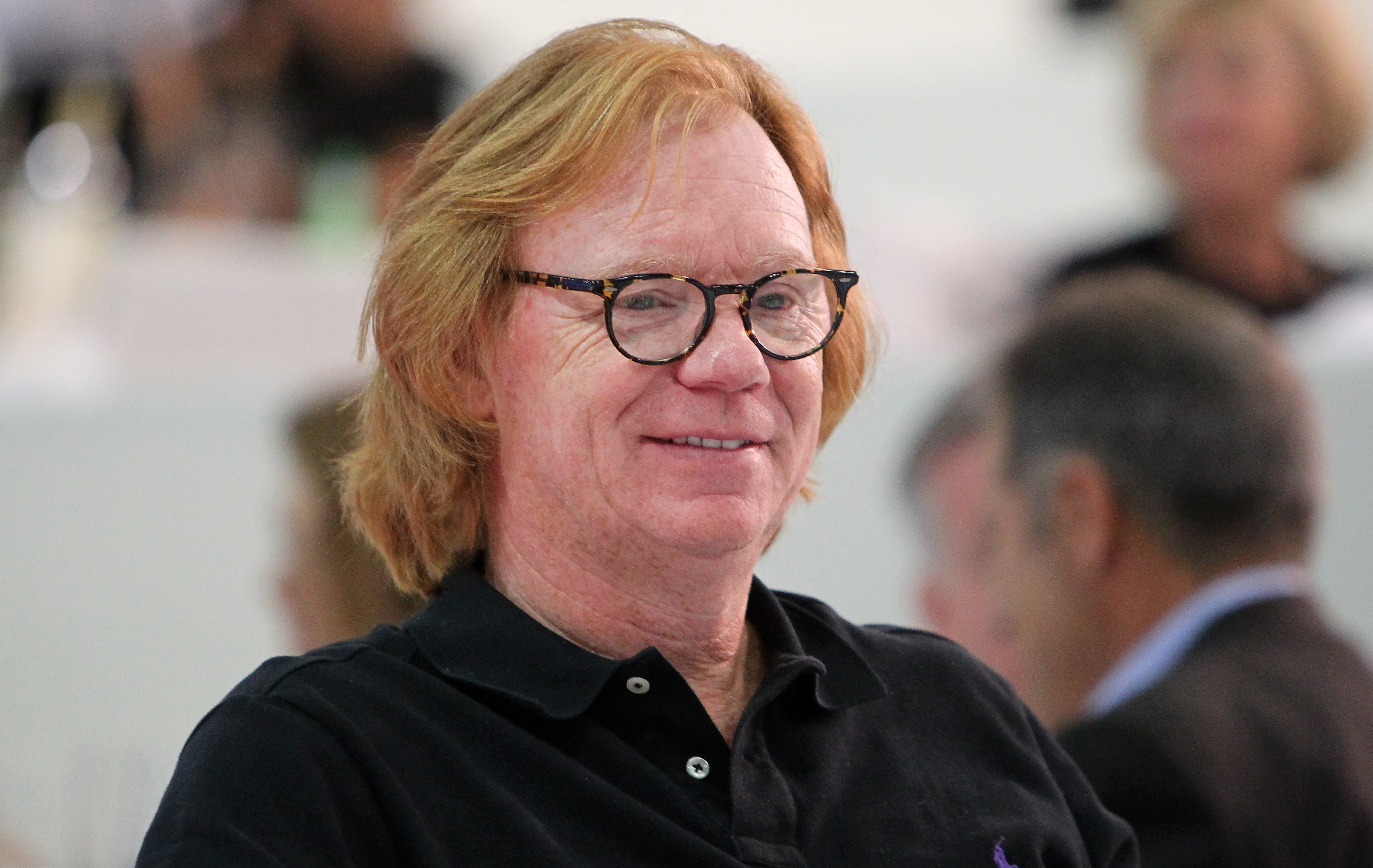 David Caruso smiles in glasses and a black polo while attending the Longines Grand Prix class event during the Longines Los Angeles Masters.