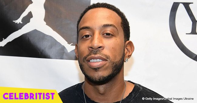 Ludacris admires wife by sharing photo of her in tight, black dress with split & high-heeled boots