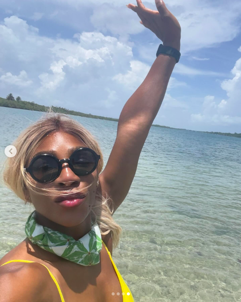 Serena Williams posing with her arm in the air, posted on August 21, 2025. | Source: Instagram/serenawilliams