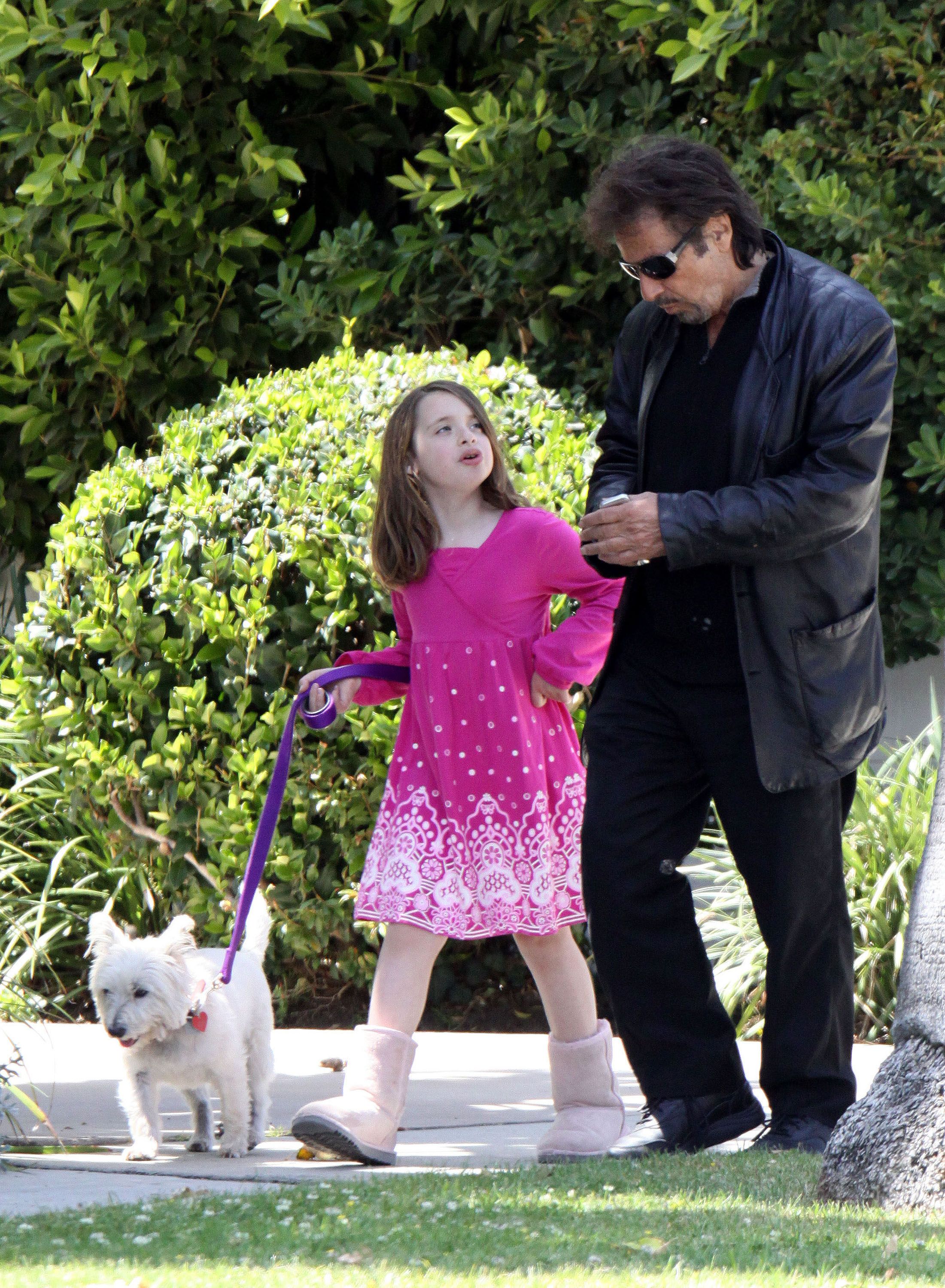Al Pacino and his daughter walking a dog | Source: Getty Images