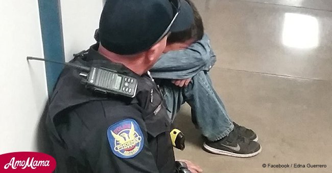 School officer sits next to crying student to calm him down