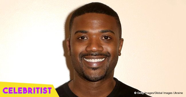 Ray J holds baby daughter with thick hair, wearing purple sports suit and white bow in new pic