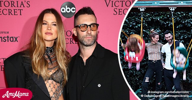 Adam Levine’s wife posts rare pic of them swinging little daughters in an intimate family moment
