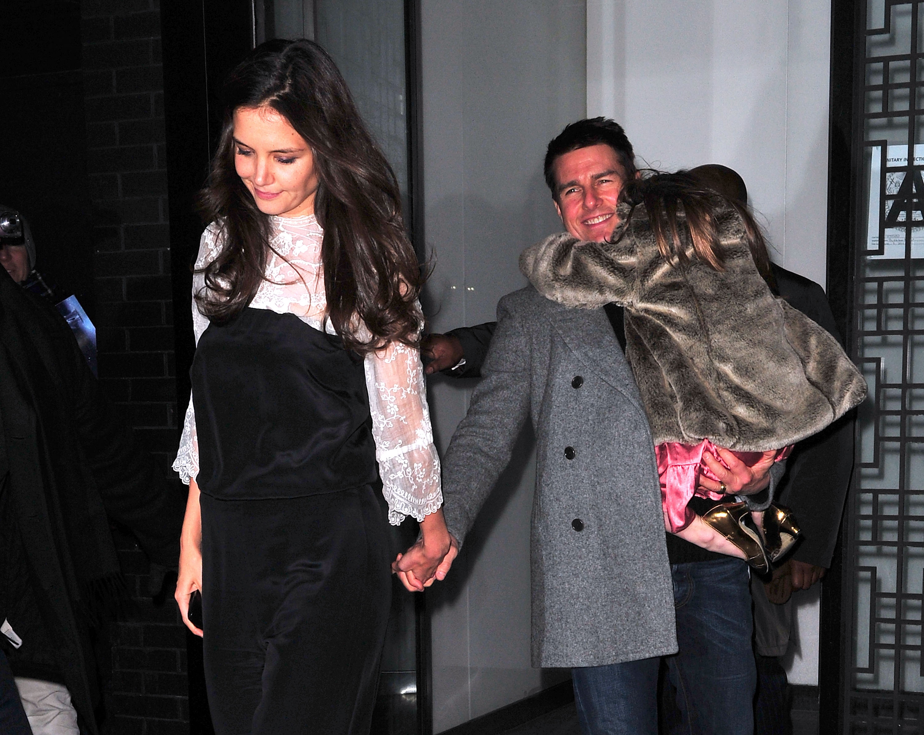 Katie Holmes, Tom Cruise, and Suri Cruise leave Buddakan after celebrating Katie's birthday on December 18, 2011, in New York City | Source: Getty Images