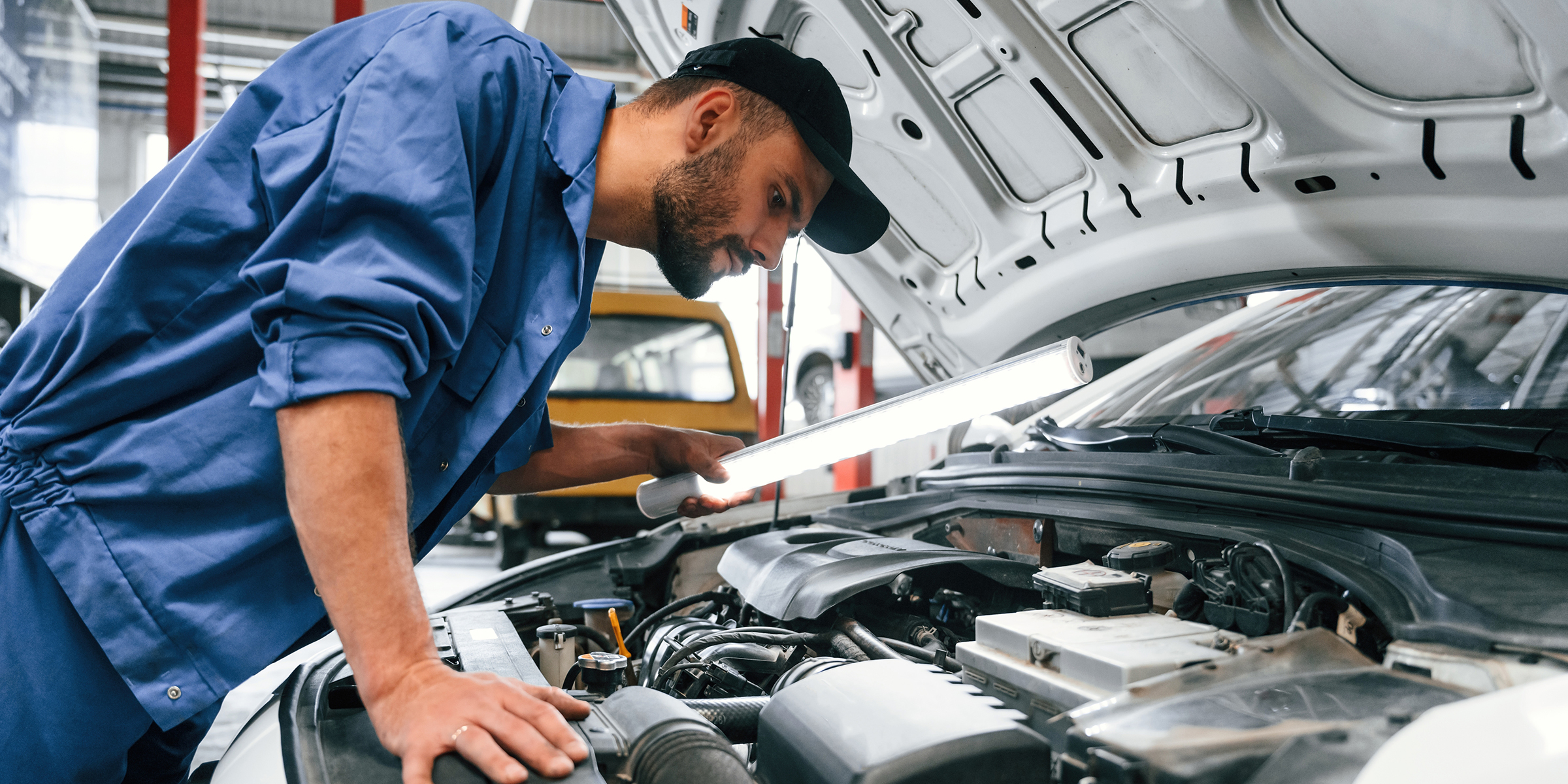 A mechanic working on a car | Source: Shutterstock