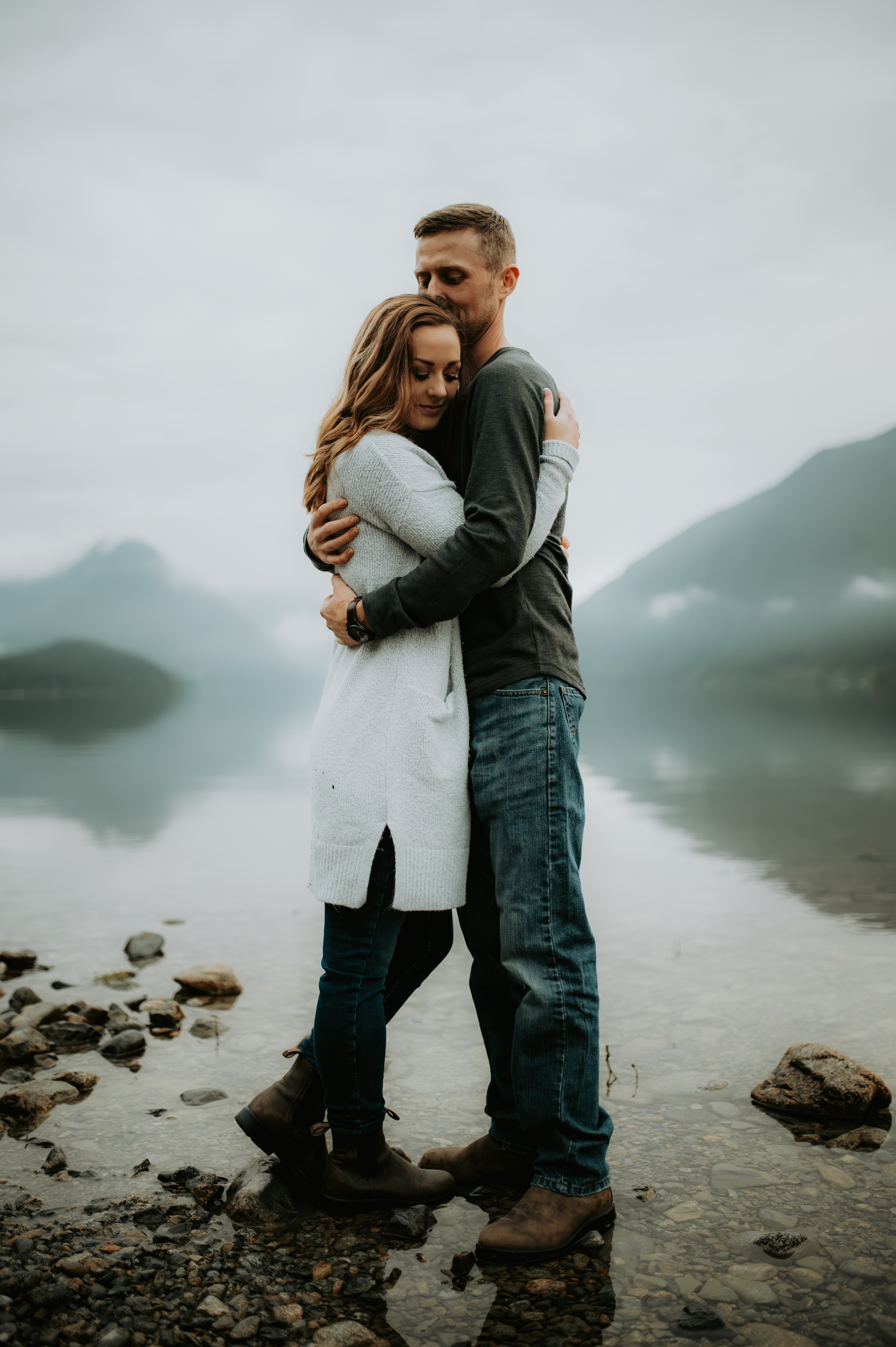 A Couple Standing on the Riverbank in a Mountain Valley. | Source: Pexels