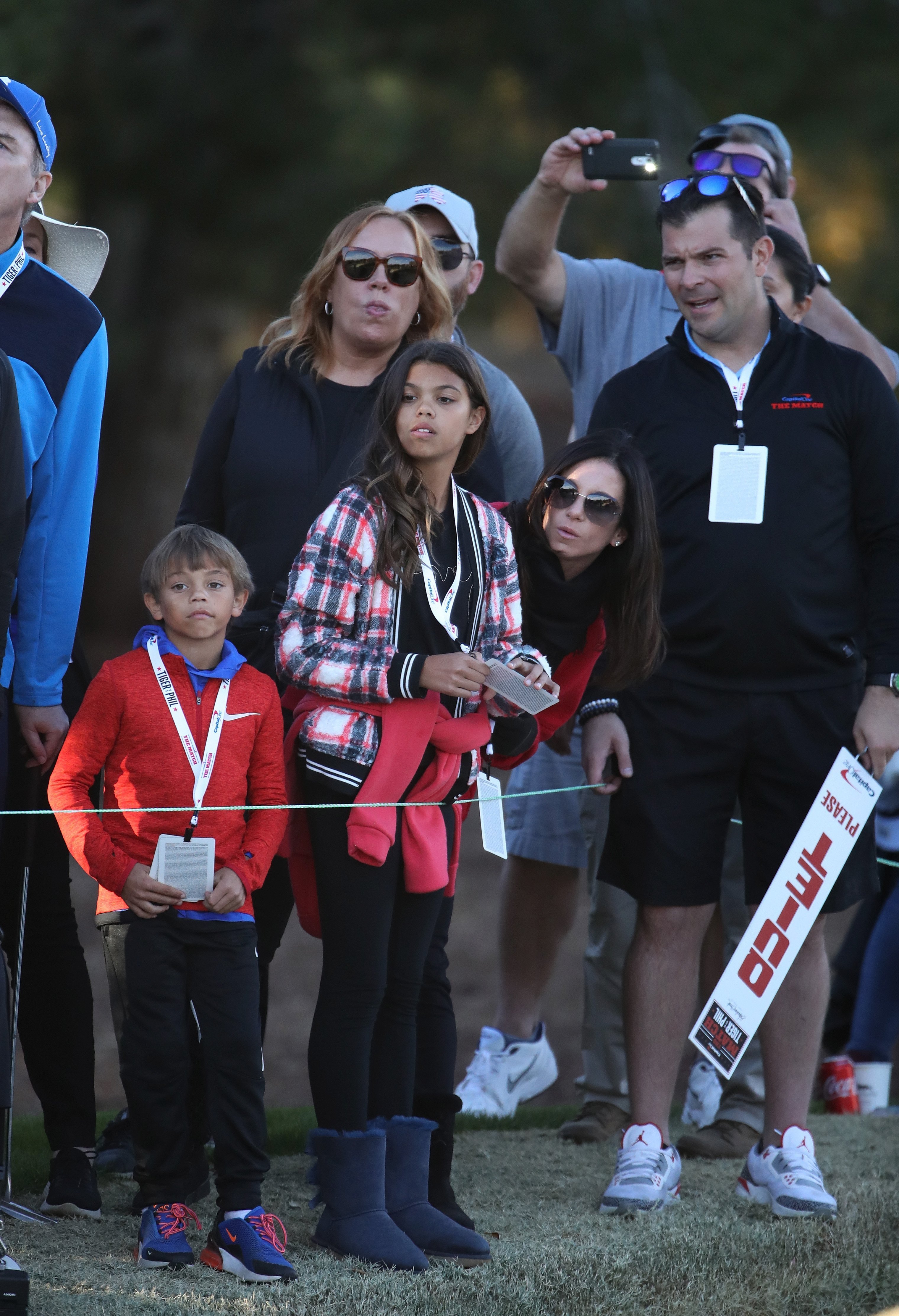 Erica Herman, girlfriend of Tiger Woods, and his children Sam and Charlie look on during The Match: Tiger vs Phil at Shadow Creek Golf Course on November 23, 2018, in Las Vegas, Nevada. | Source: Getty Images.