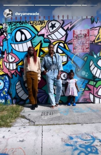 Dwyane Wade's daughter, Zaya, posing for a picture with her half sister, Kaavia and stepmom Gabrielle Union in front of a mural | Photo: Instagram/dwyanewade