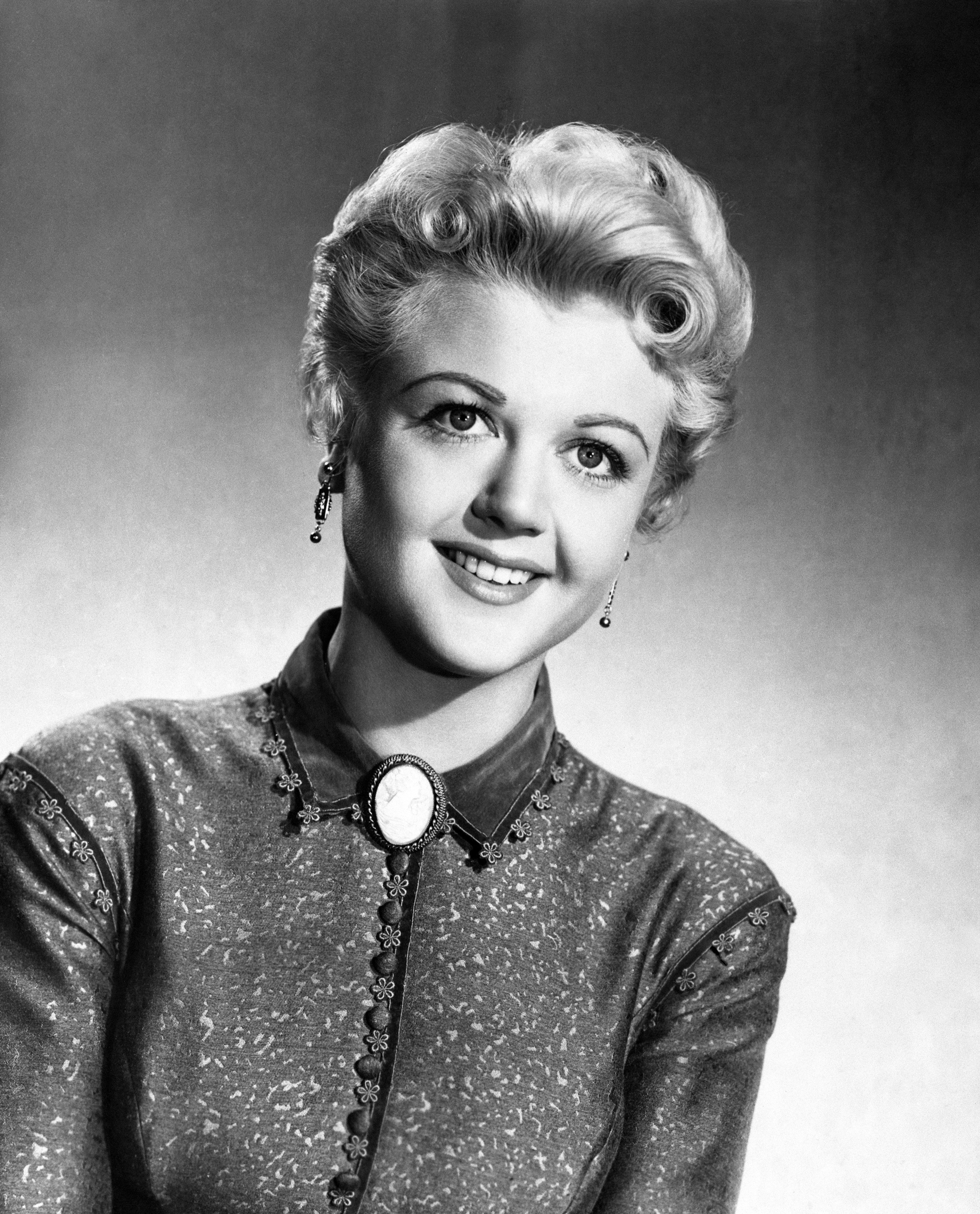 British actress Angela Lansbury, who is returning to the screen after an absence of three years in a Columbia Pictures Western 'A Lawless Street'. Angela is the granddaughter of the famous politician George Lansbury. She might have gone into politics herself, but her mother was a stage star and the theatre was the overriding influence in her home.| Source:  Getty Images